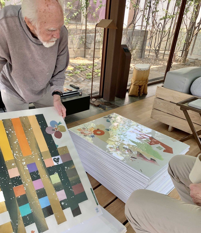 Austin Lowrey examining a colorful artwork