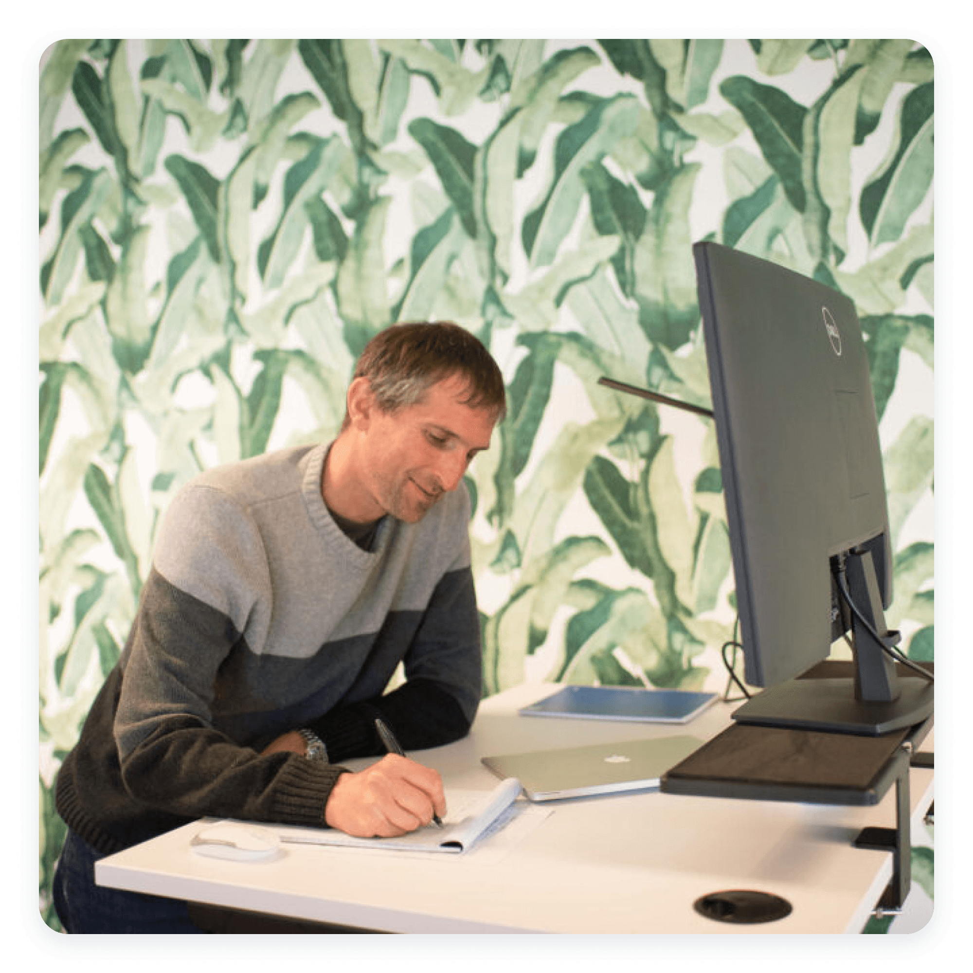 Photograph of one team member taking notes at a desk