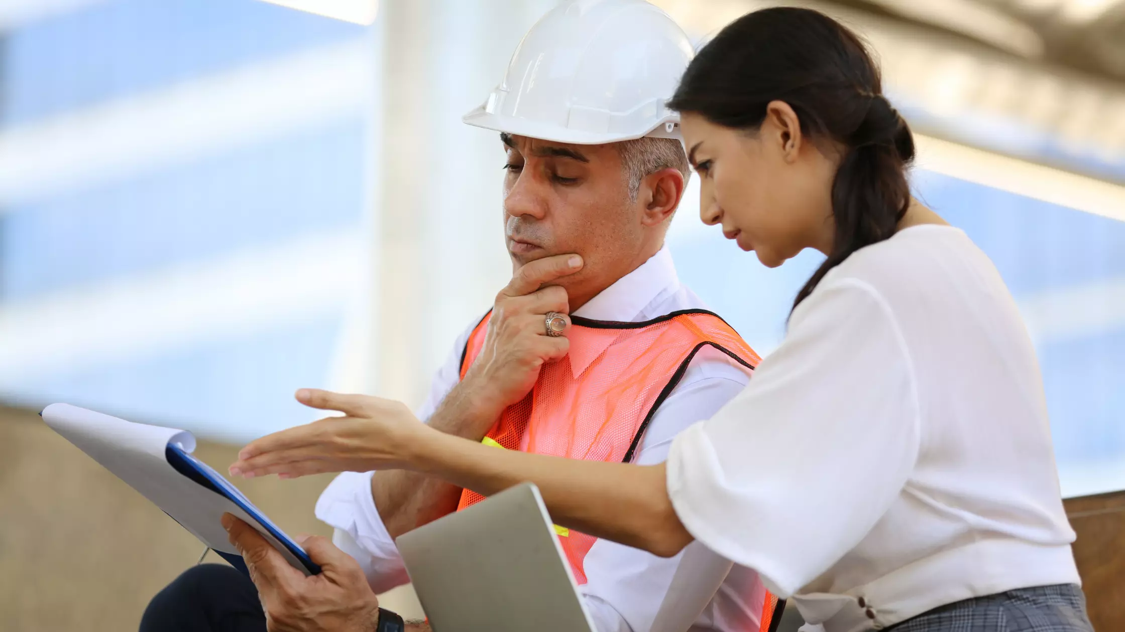 Contractor reviewing with the teammates, about the project in the site, image 