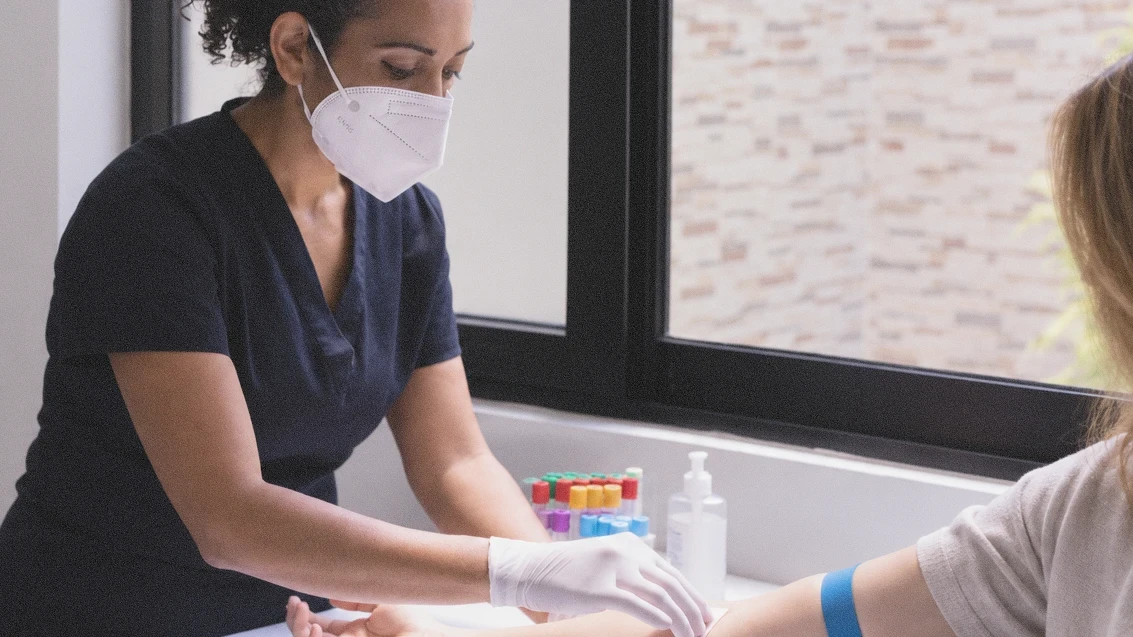a nurse administering a blood test in a calm Melbourne setting
