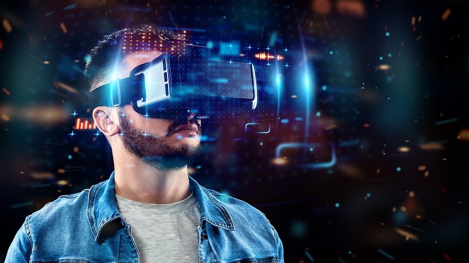 a man wearing virtual reality goggles with dark background