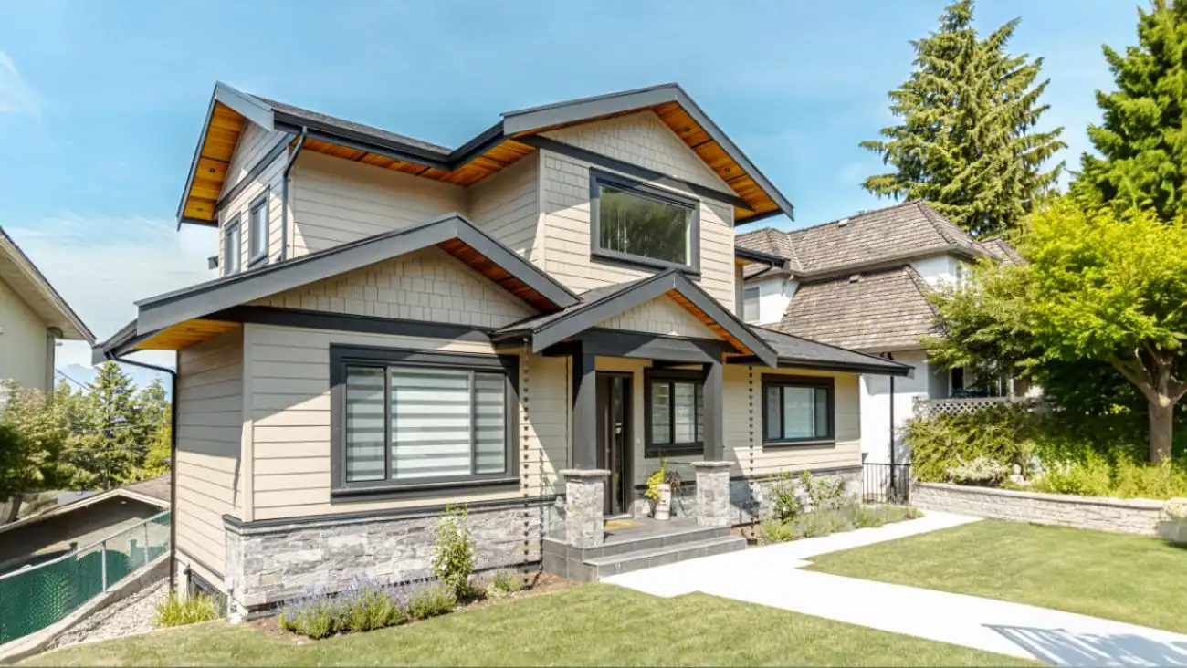 Two-story custom home exterior with natural stone accents and covered porch in Burnaby built by Vancouver Custom Homes