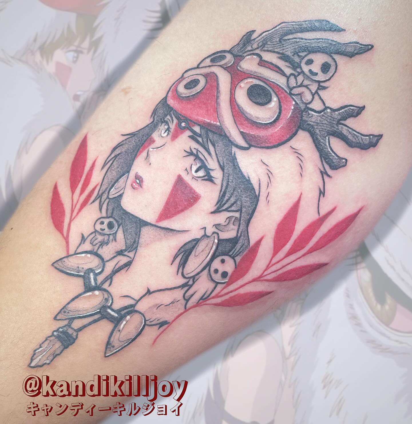 A vibrant tattoo of a chainsaw-like creature on a person's forearm. The tattoo is detailed with shades of orange, black, teal, and red.