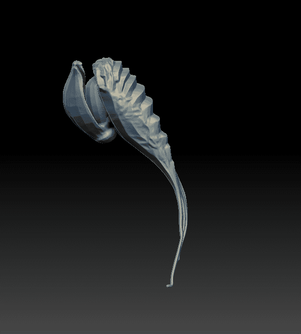 Elongated plant sculpt with layered leaf-like ridges along one side.