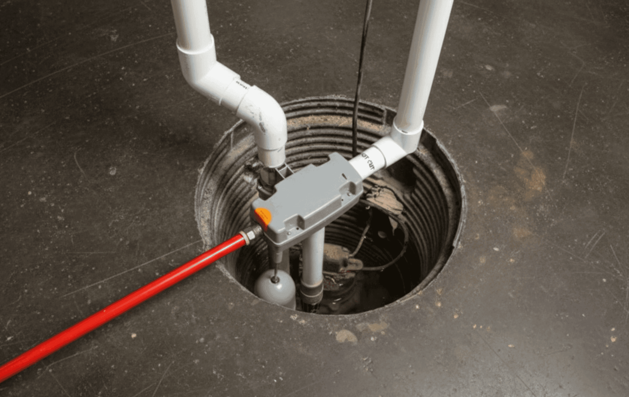 A sump pump with a vibrant red handle and hose, utilized for effective water management in various settings, by Automech Group