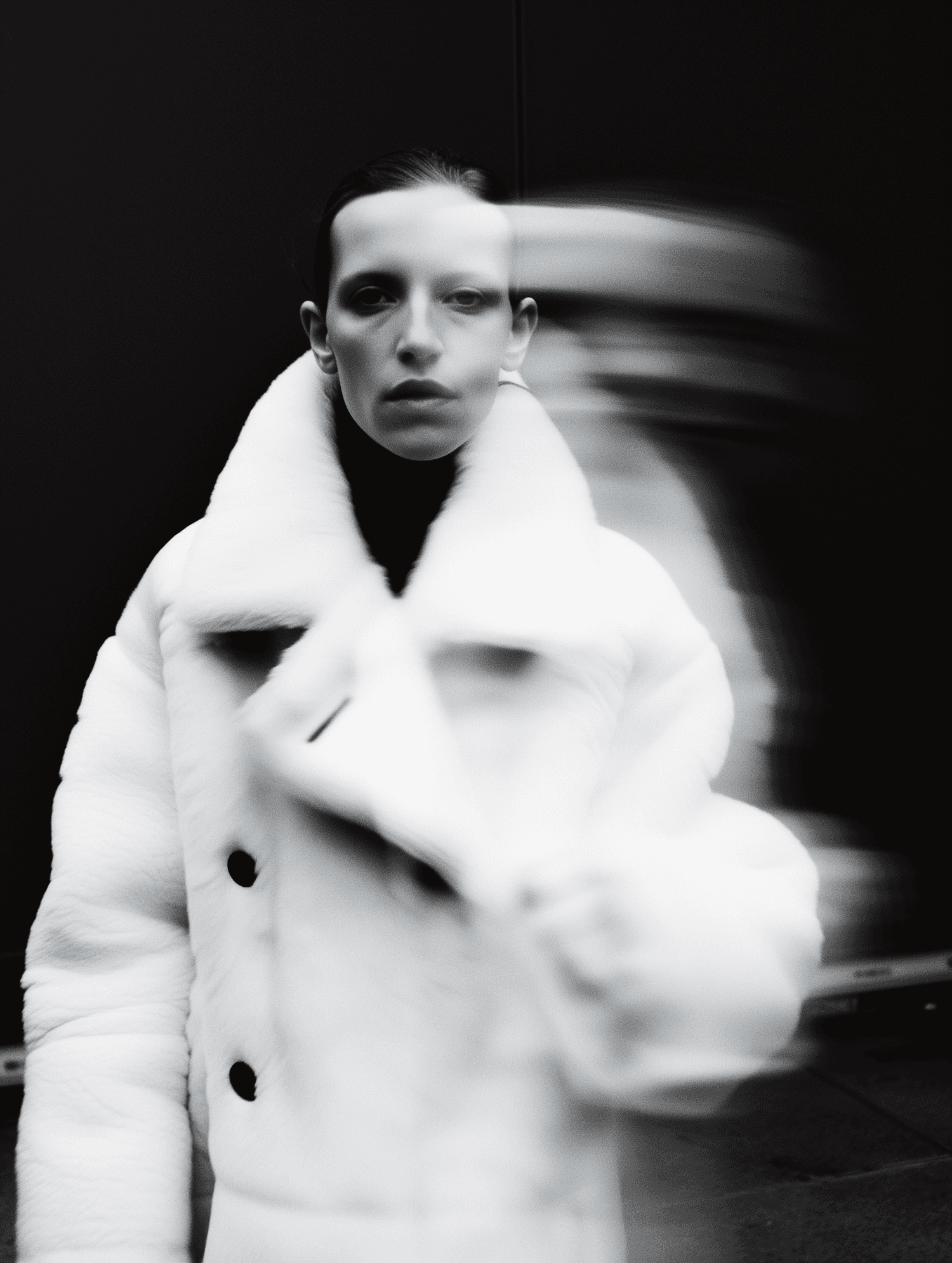 Woman in white coat, motion-blurred