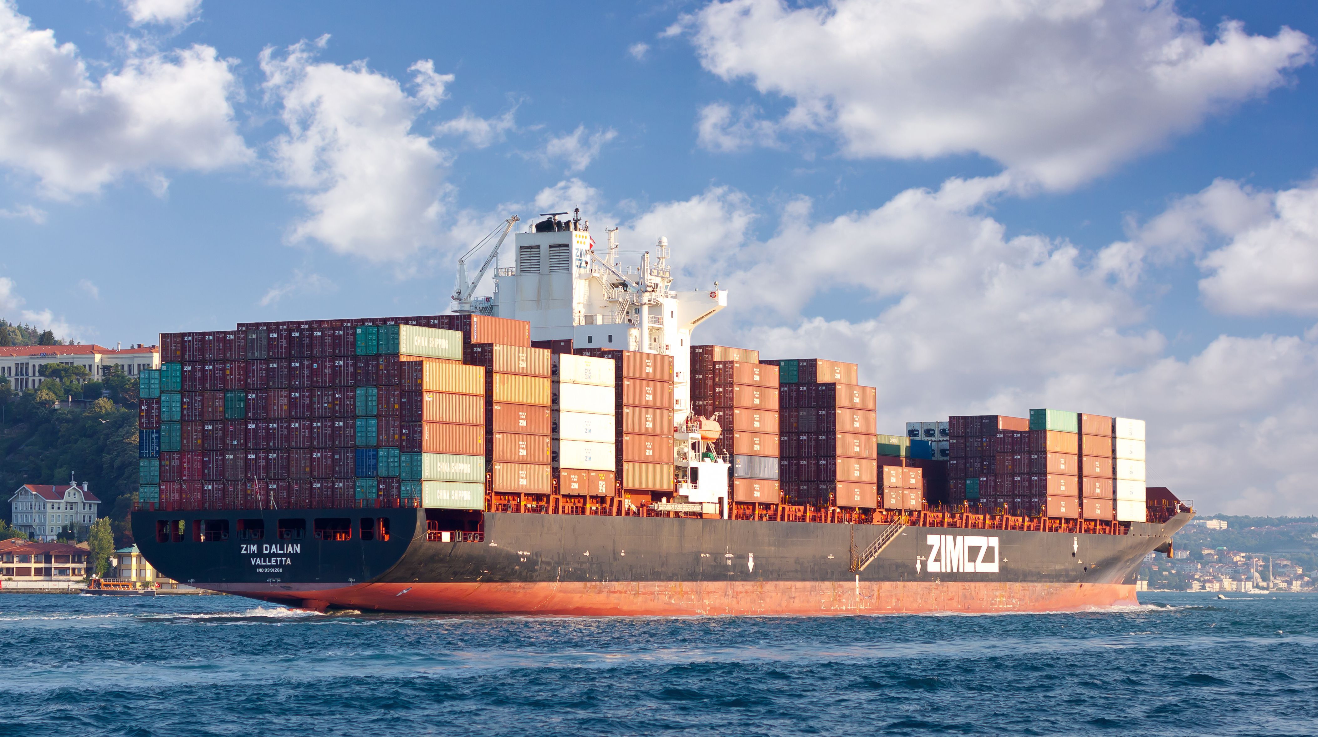 This is the image of the vessel of a ZIM shipping lines company floating in blue ocean.