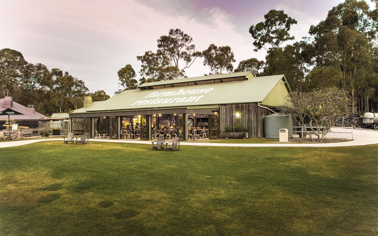 Farmhouse Restaurant at Paradise Country with outdoor seating and surrounding trees.