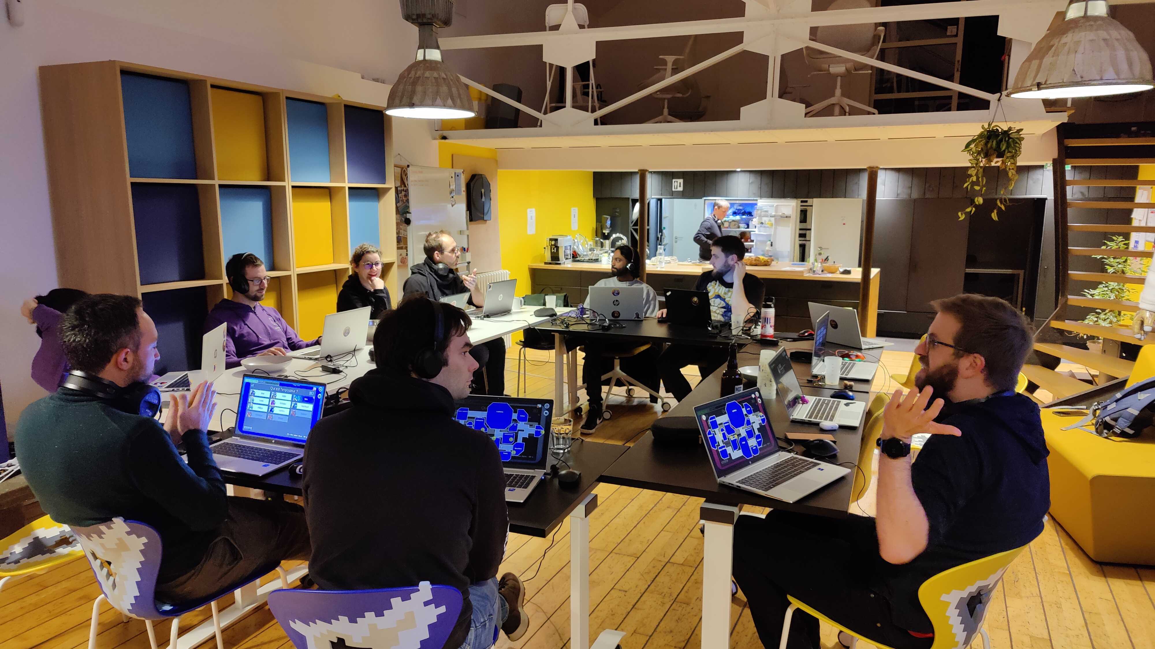 groupe de personnes assises en train de jouer à des jeux sur leur ordinateur