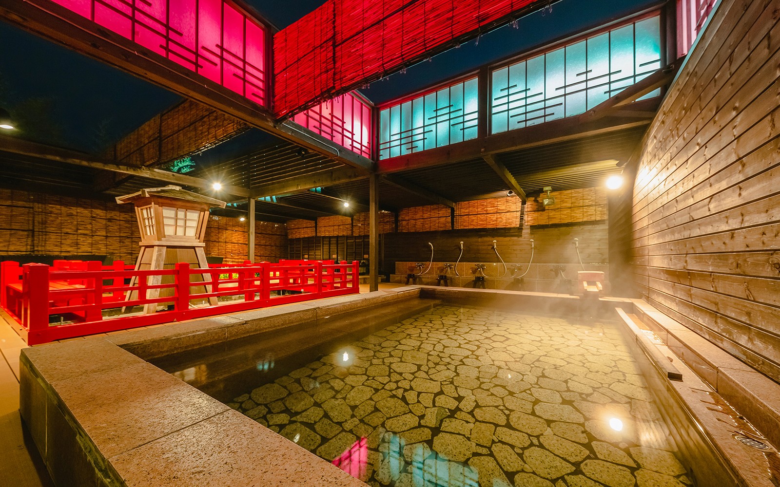 Arima Onsen Taiko No Yu Spa indoor hot spring with red wooden railings and stone floor.