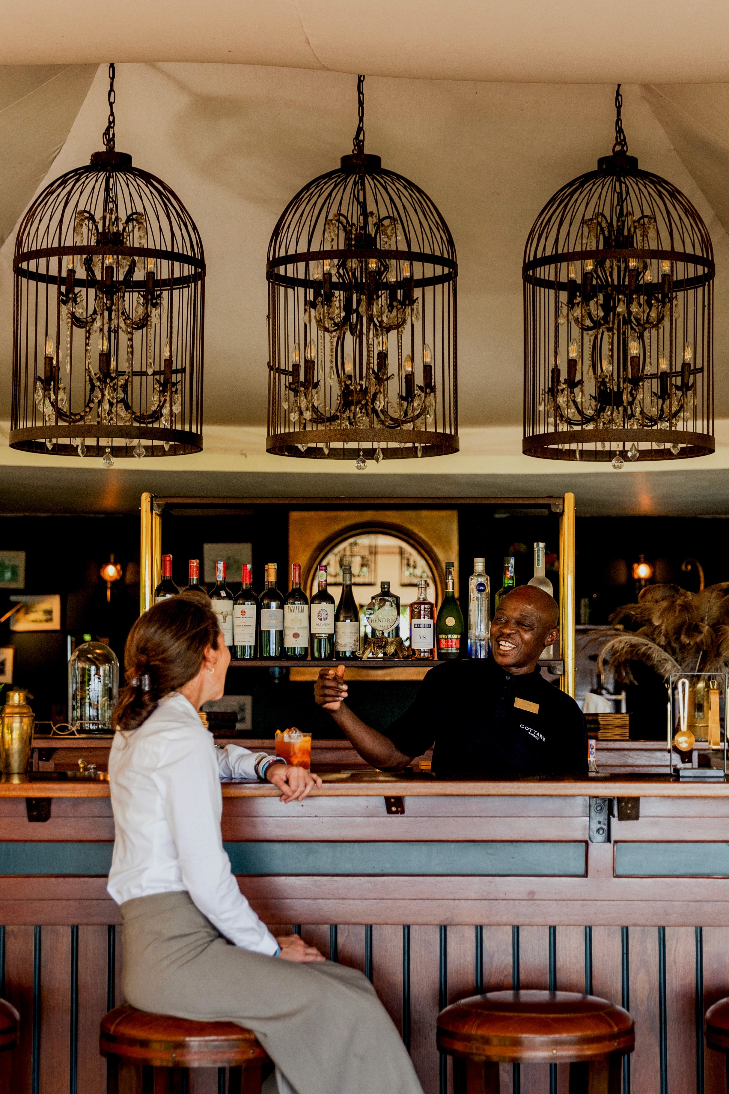 Gold Standard Cottars 1920's Safari Camp and Bush Villa Maasai guide describing the migration to guests, Maasai Mara, Kenya