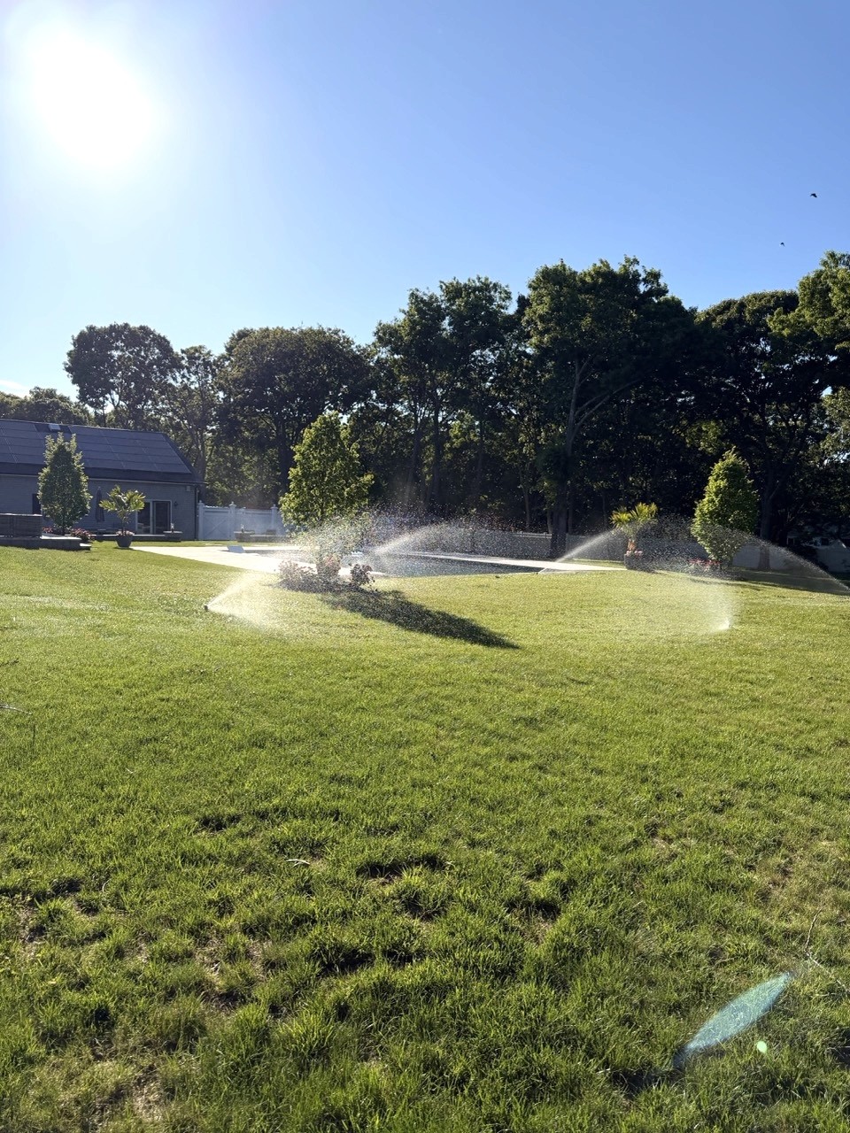 Sprinkler system watering a green lawn by Bonilla Irrigation & Contracting, Long Island NY