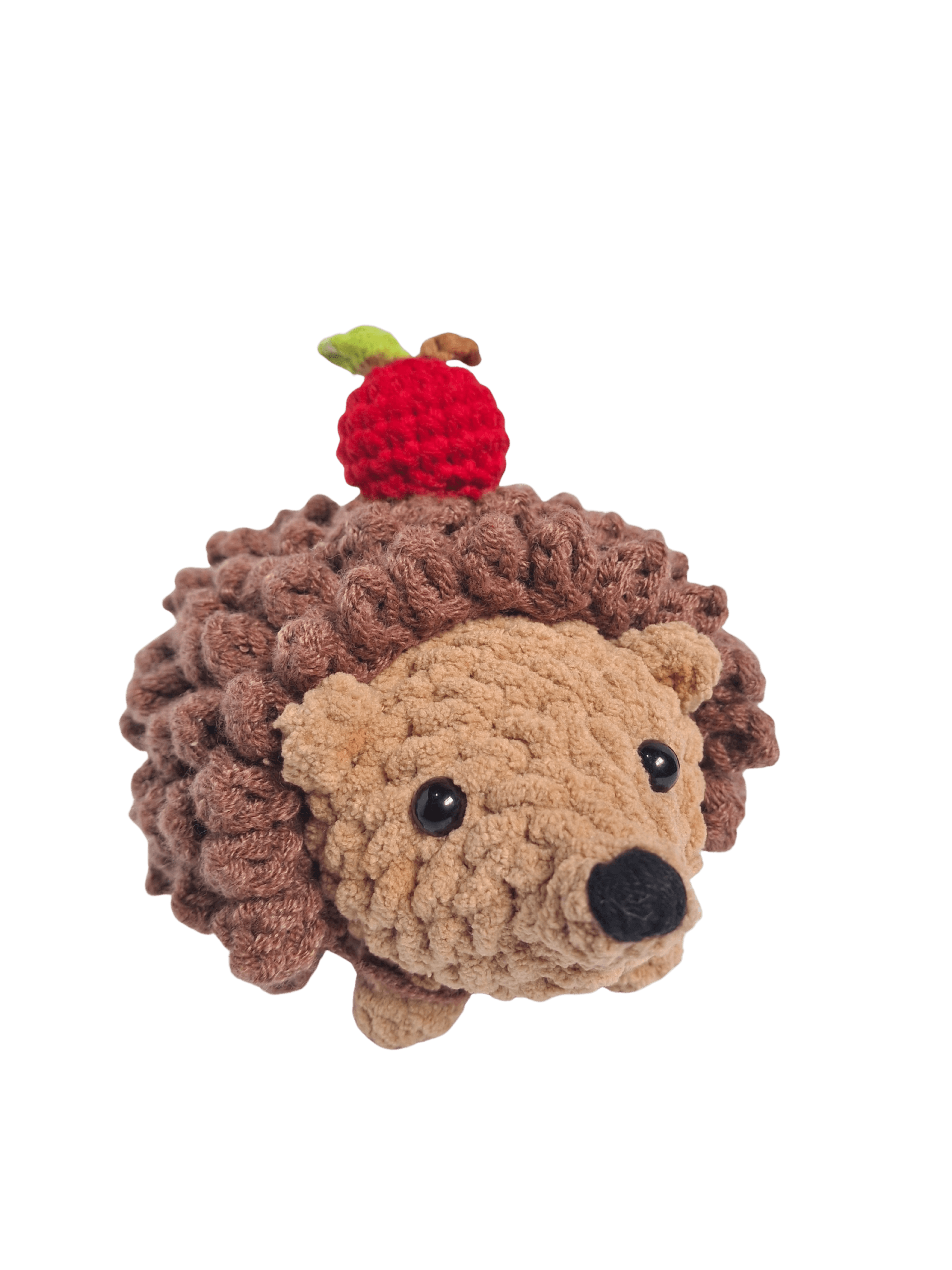 A cute, handcrafted plush hedgehog toy with brown yarn spikes and large, friendly eyes sits facing forward on a white background.