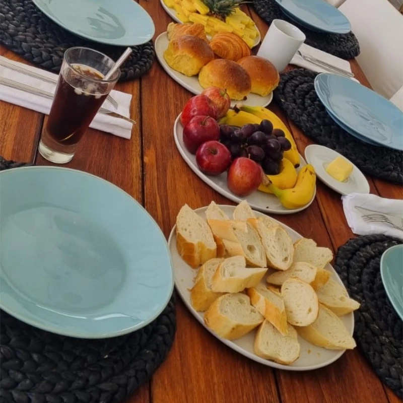 Table with multiple brakfast dishes.