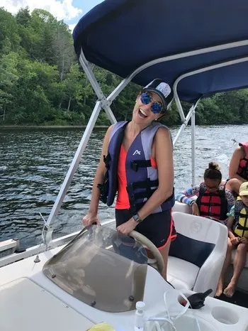Stephanie Moss driving the ski boat on the lake