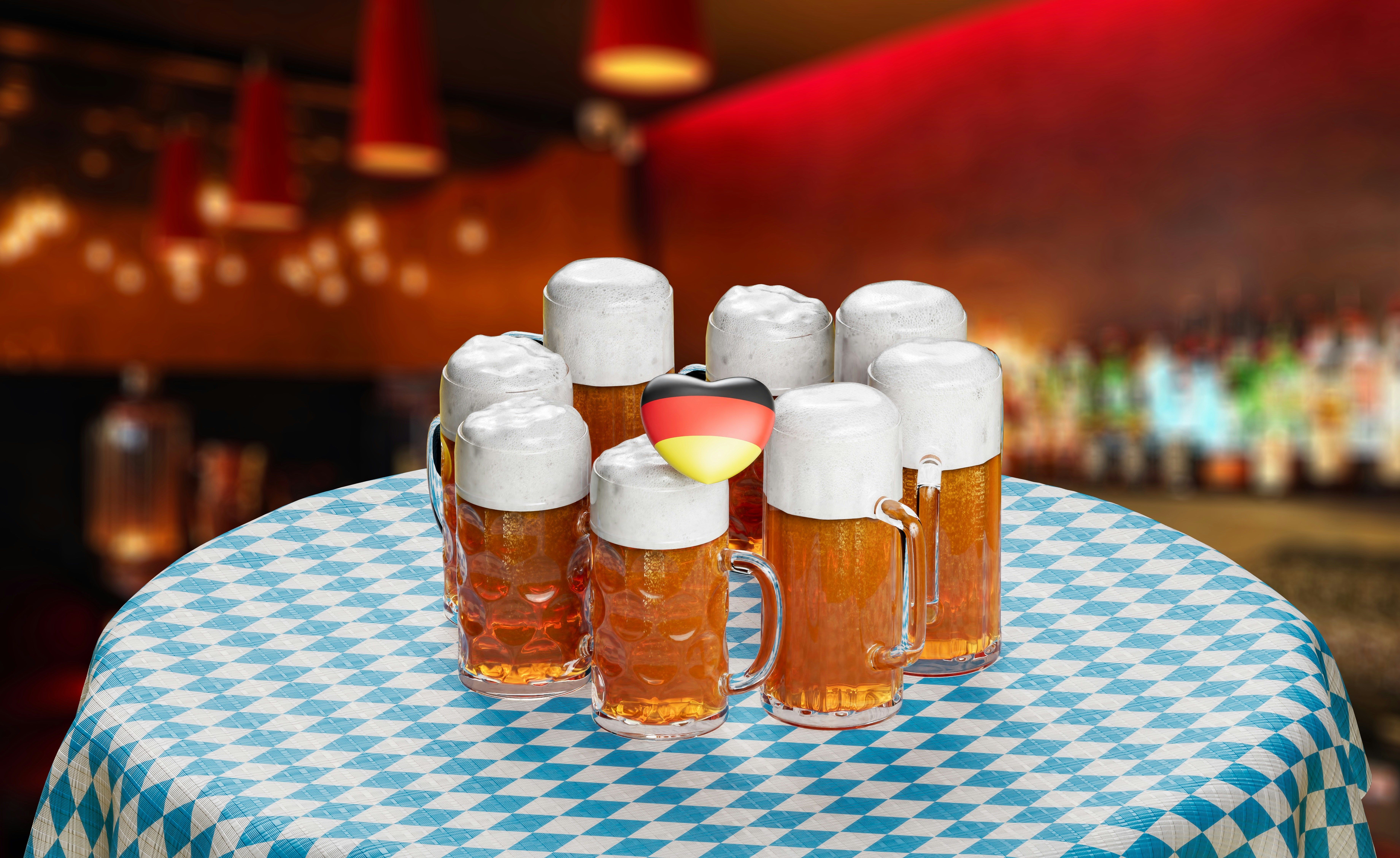 Liter mugs of amber beer on a blue checkered table