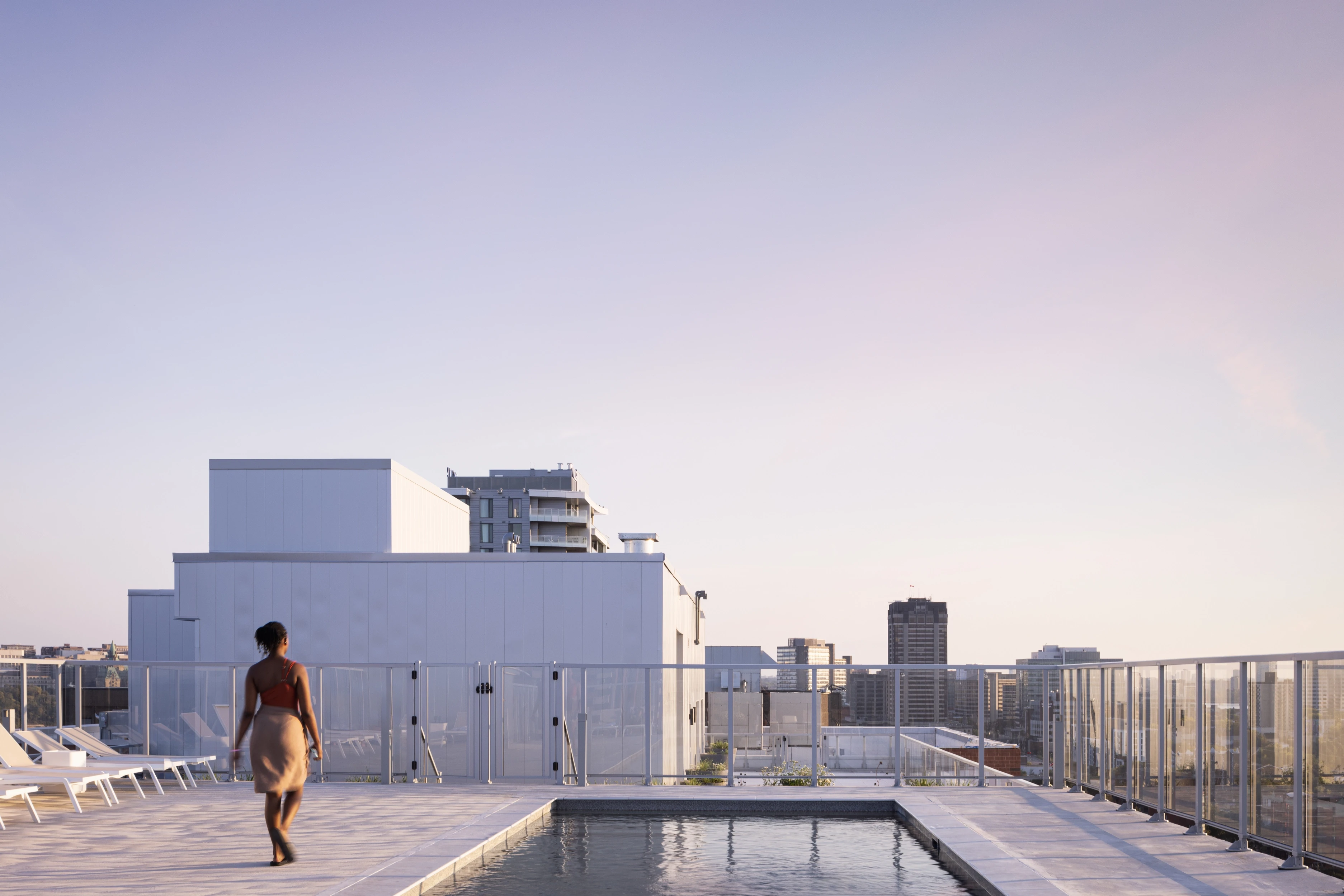 Rooftop view of Éléonore residential complex at sunset, capturing the urban skyline and the building’s interplay of textures.