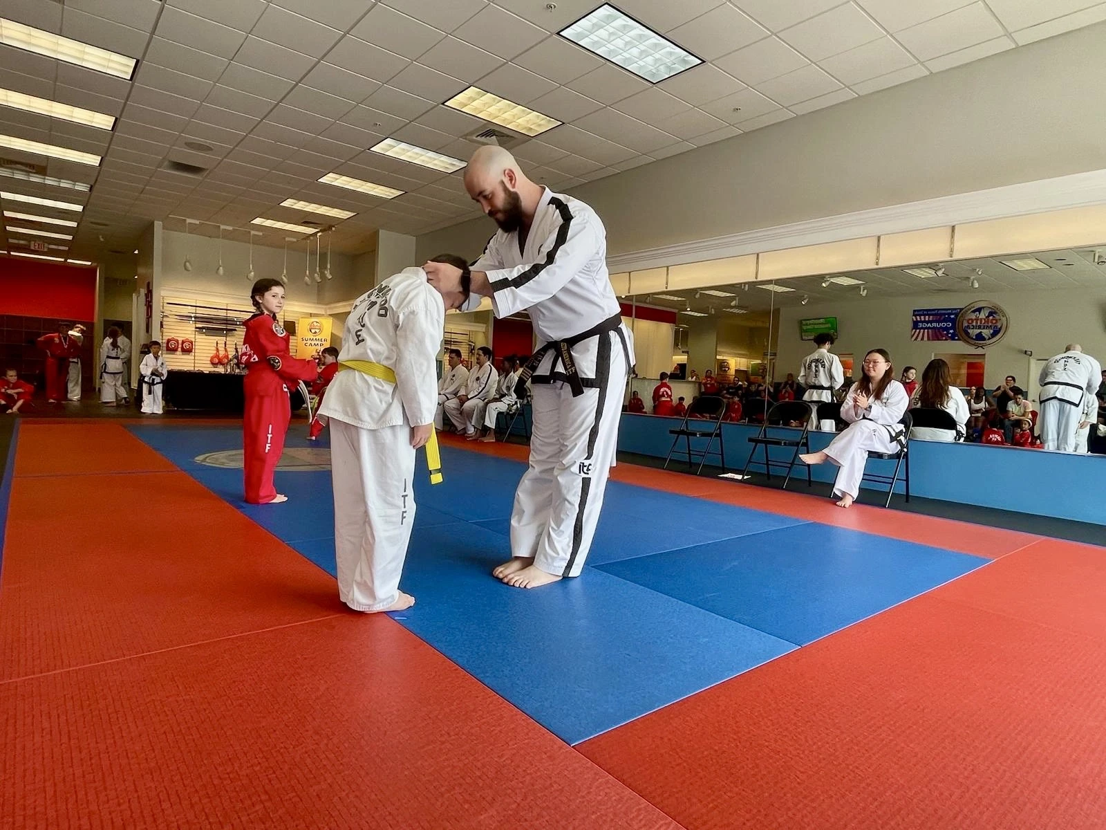 Instructor putting an award over a student's head.