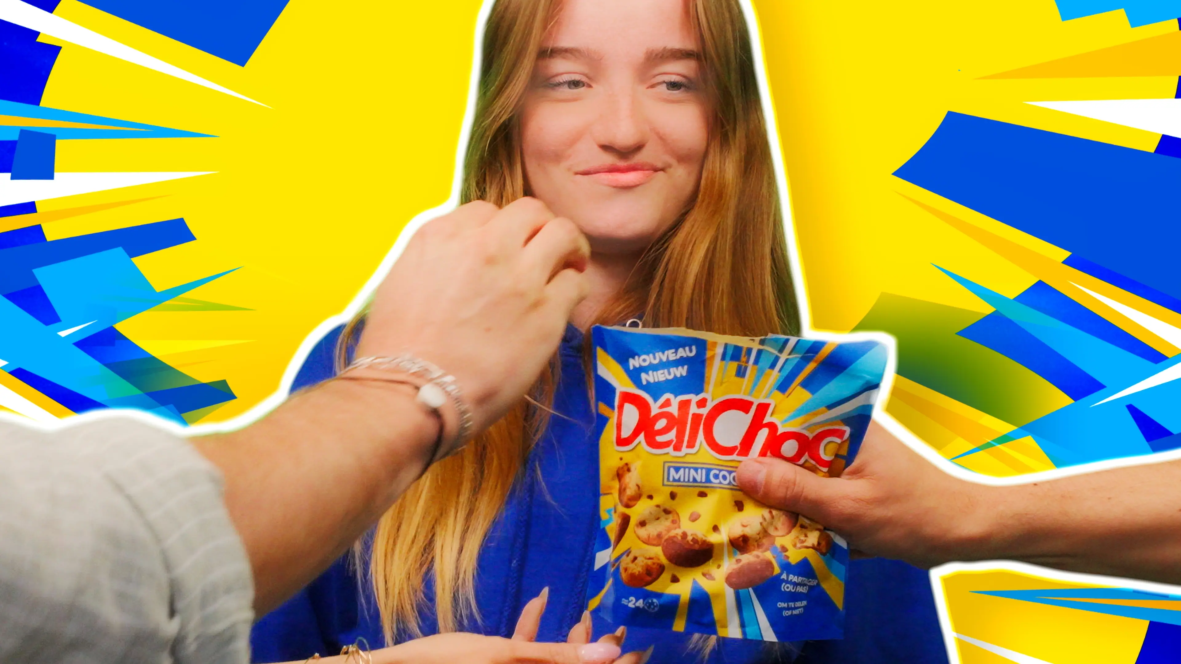 A person stands against a vibrant yellow and blue abstract background, holding a bag of DeliChoc mini cookies, while another hand reaches toward the bag.
