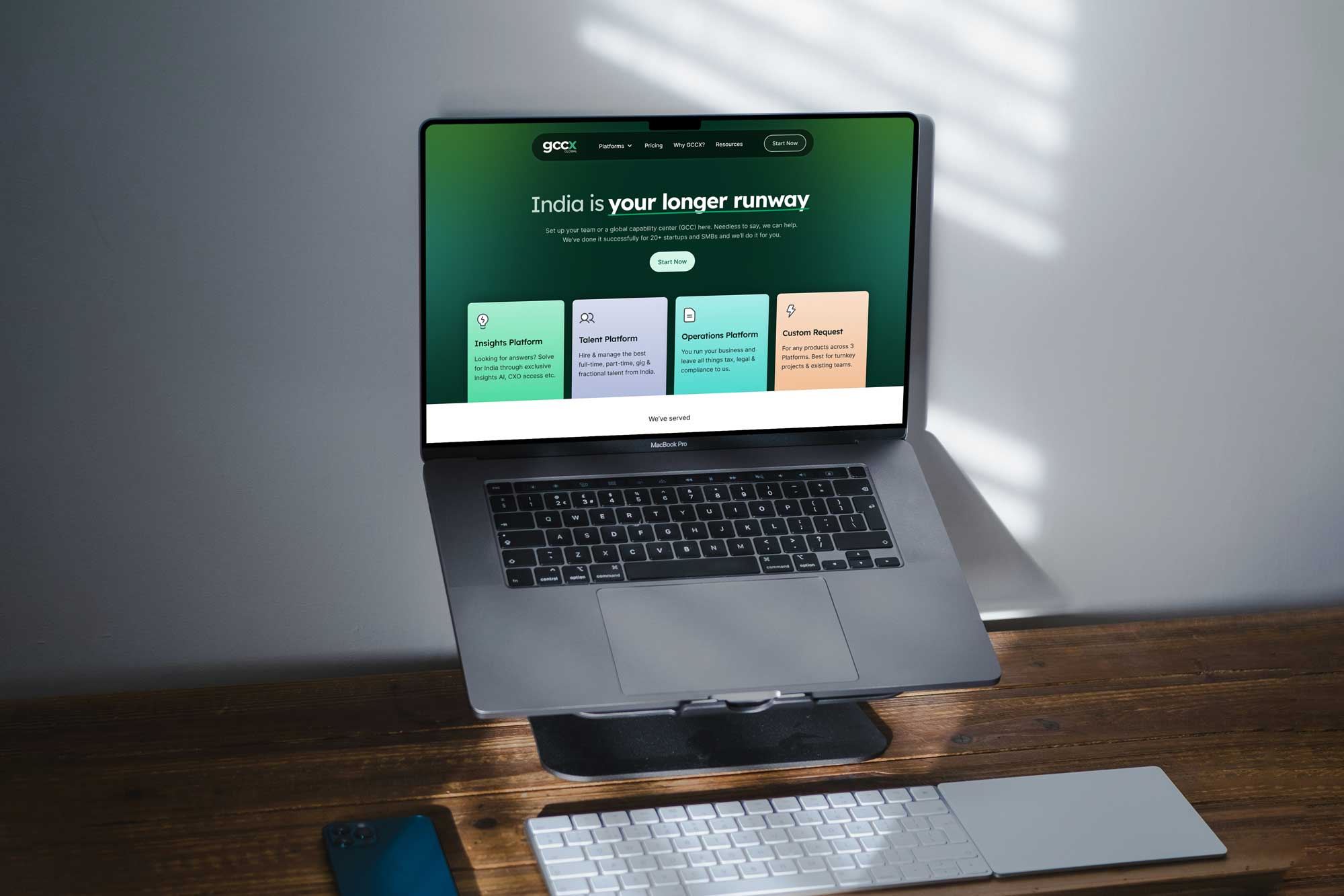 GCCX Global Capability Centre platform website displayed on laptop showing green dashboard with 'India is your longer runway' headline and GCC setup advisory interface