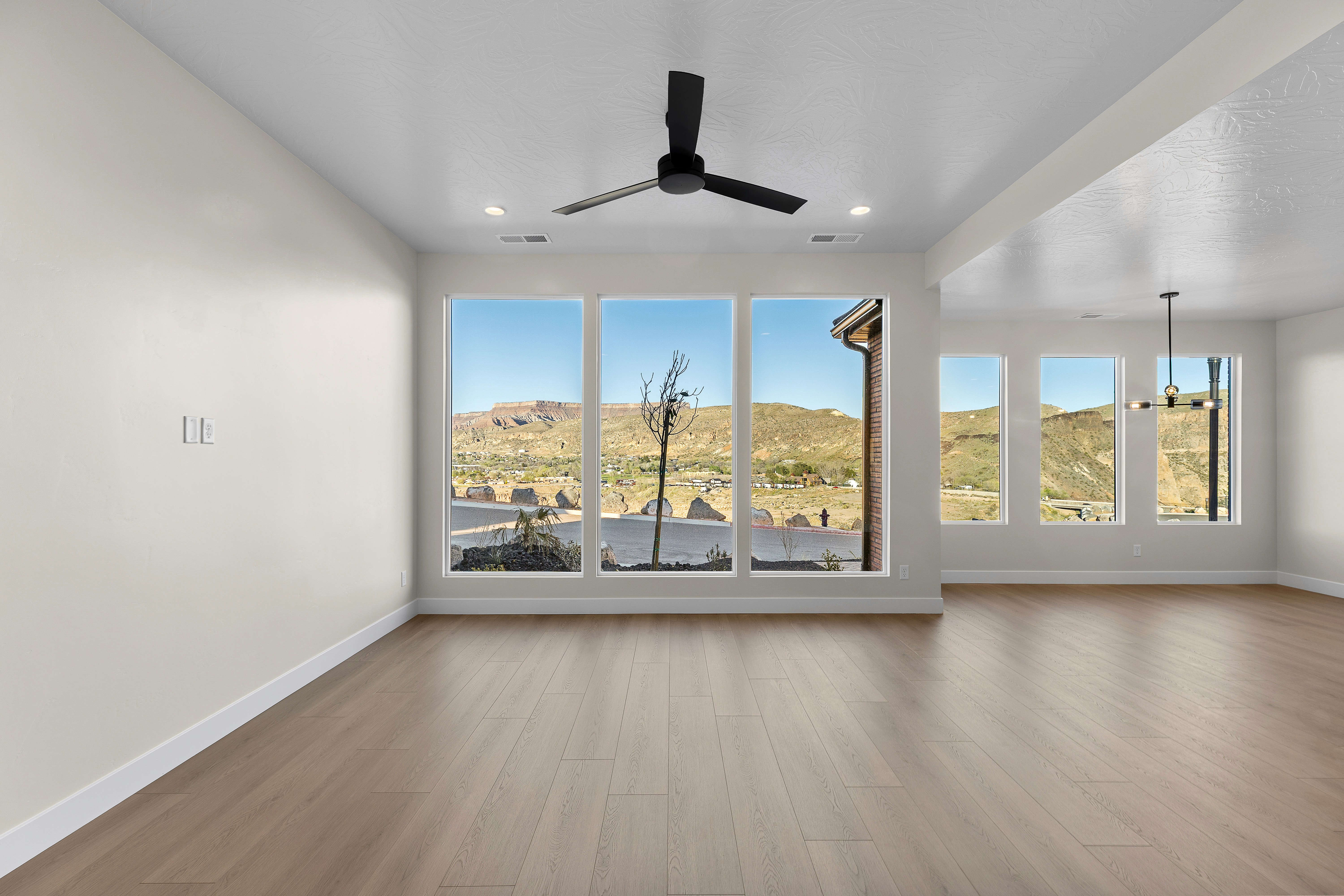 Living room in a Hurricane Utah custom home with large windows and views of the valley