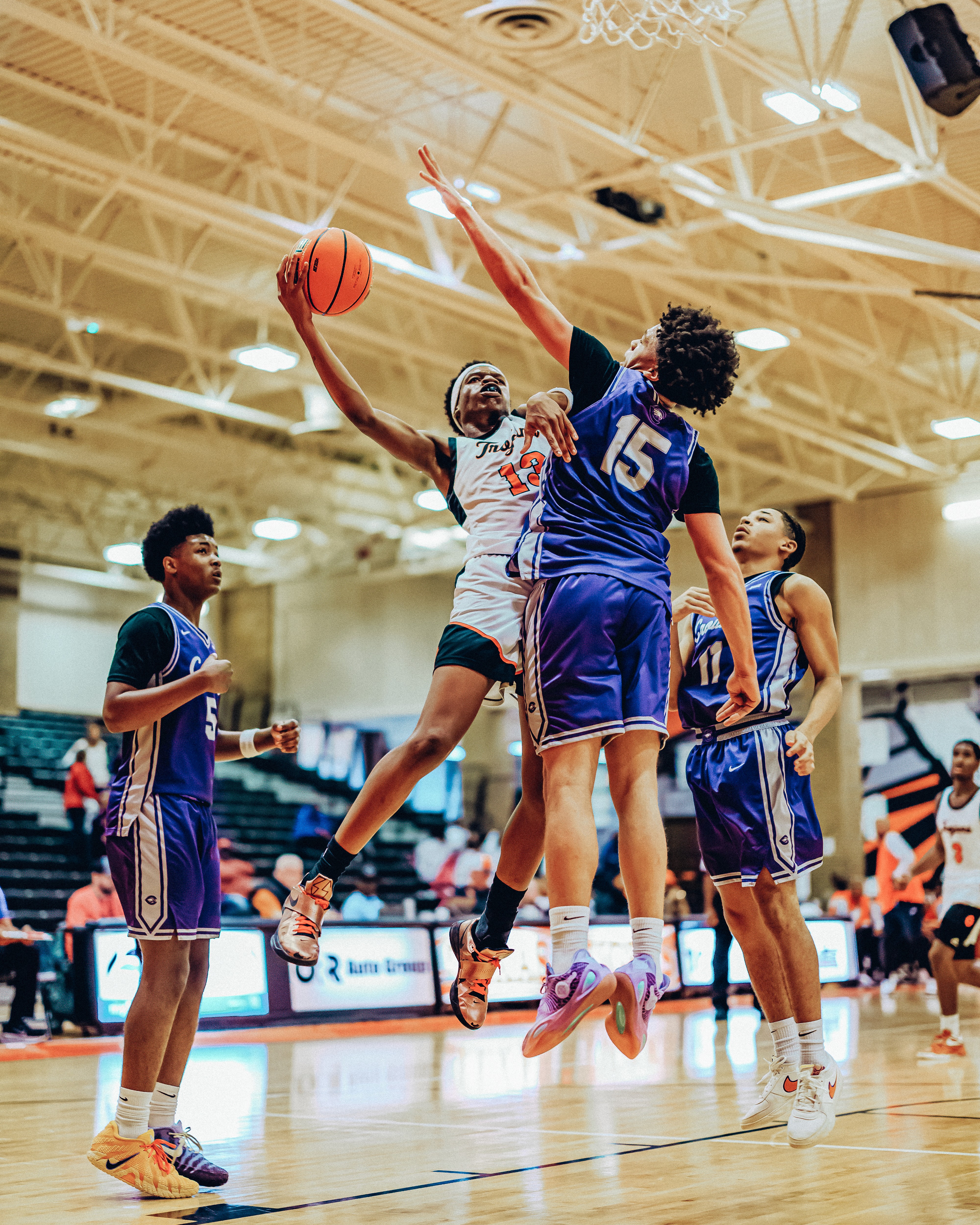 Three people sitting on a couch in a room looking at mobile devices
