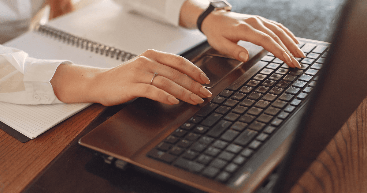 woman on laptop typing on keyboard