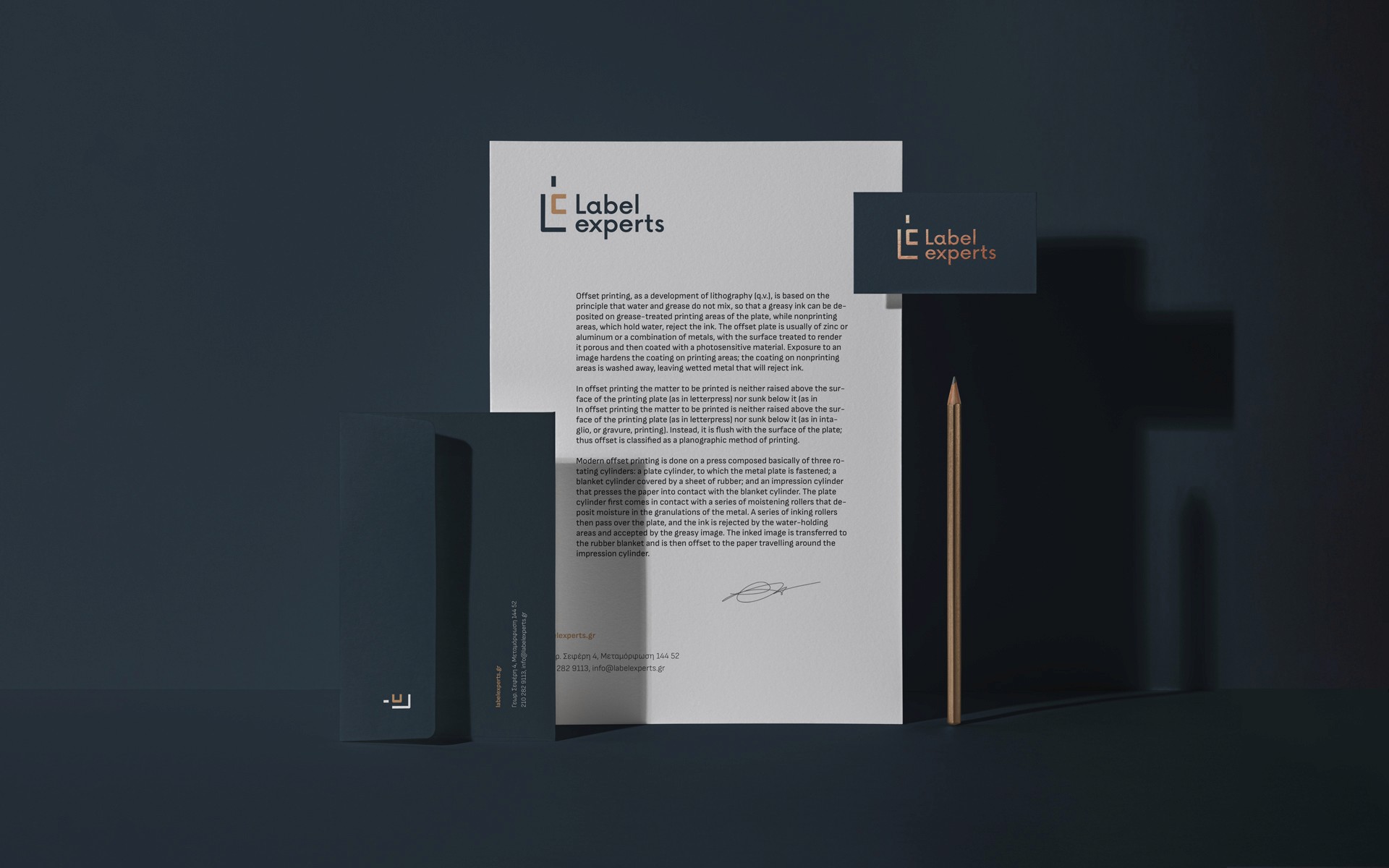 Label Experts identity applied on print materials with a dark color palette