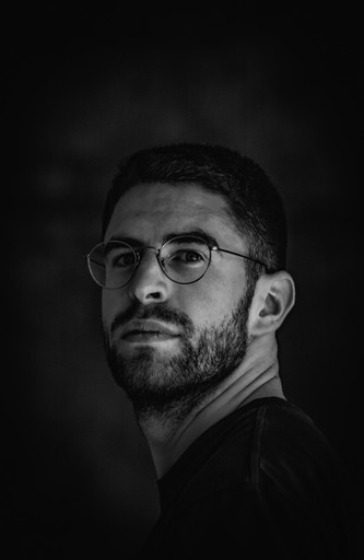 a black and white photo of a man with glasses