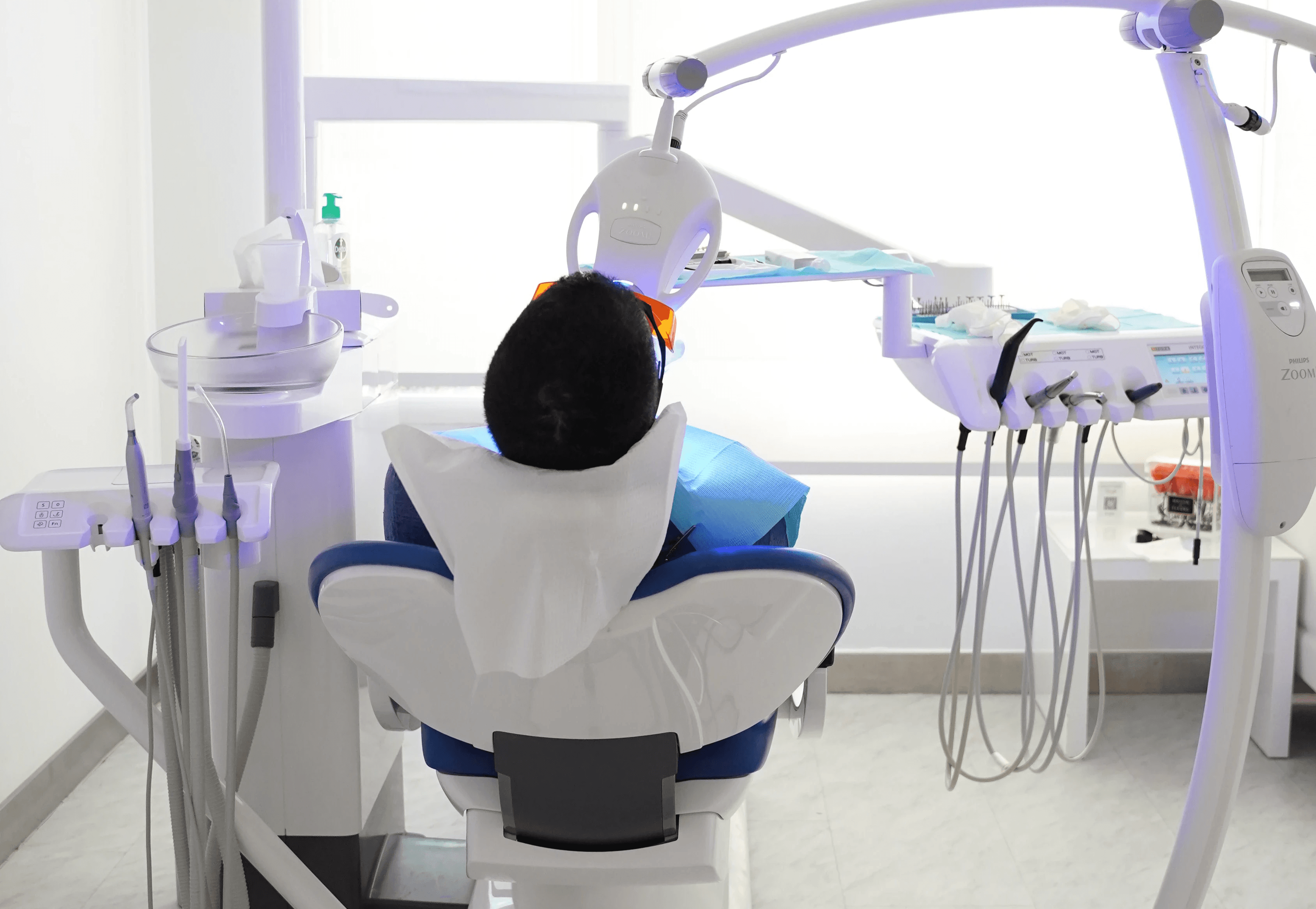 Patient lying in a dental chair receiving precise and personalized Invisalign® treatment.