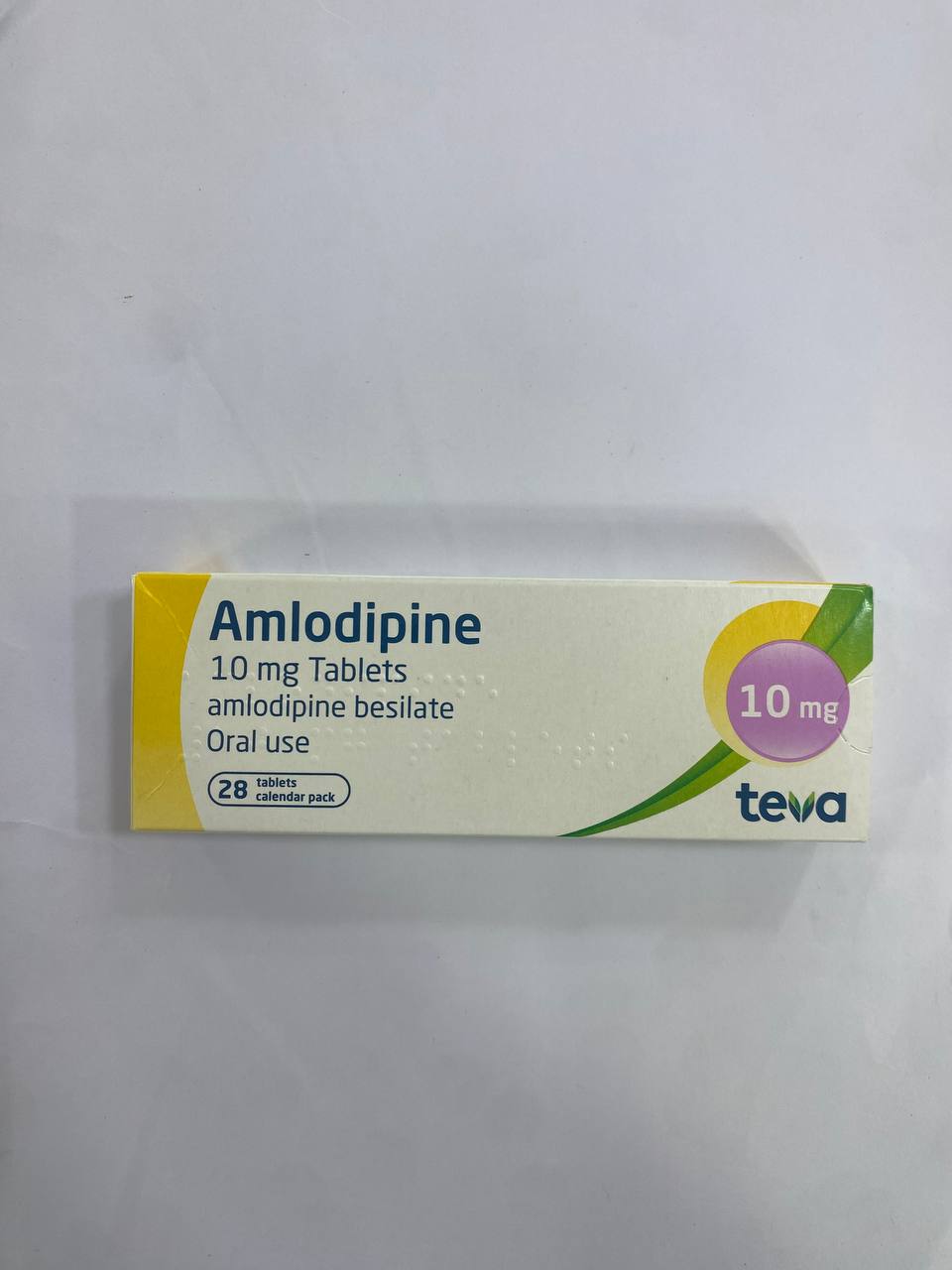 White cardboard box packaging displays a blister pack of twenty light orange tablets, labeled with green and pink text indicating a 10 mg dosage for oral use.