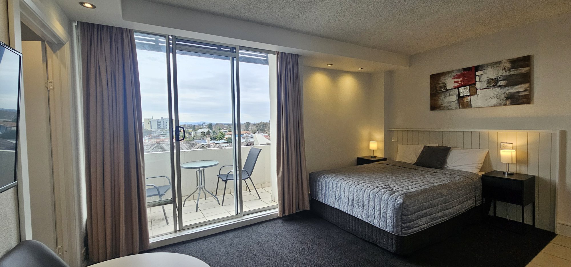 Family Apartment at Parkville Place with a queen bed and balcony overlooking Melbourne