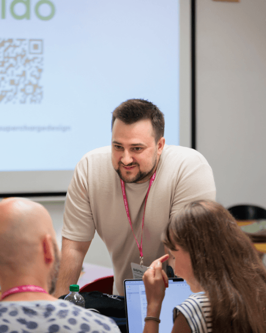 Supercharge Design team giving talks, mentoring, and connecting with the design community at conferences and workshops