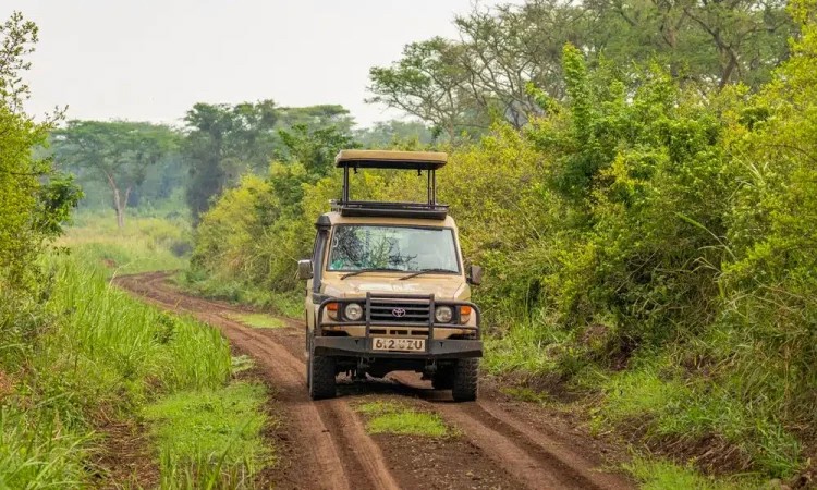 Tourist car on the road in remote areas of Uganda