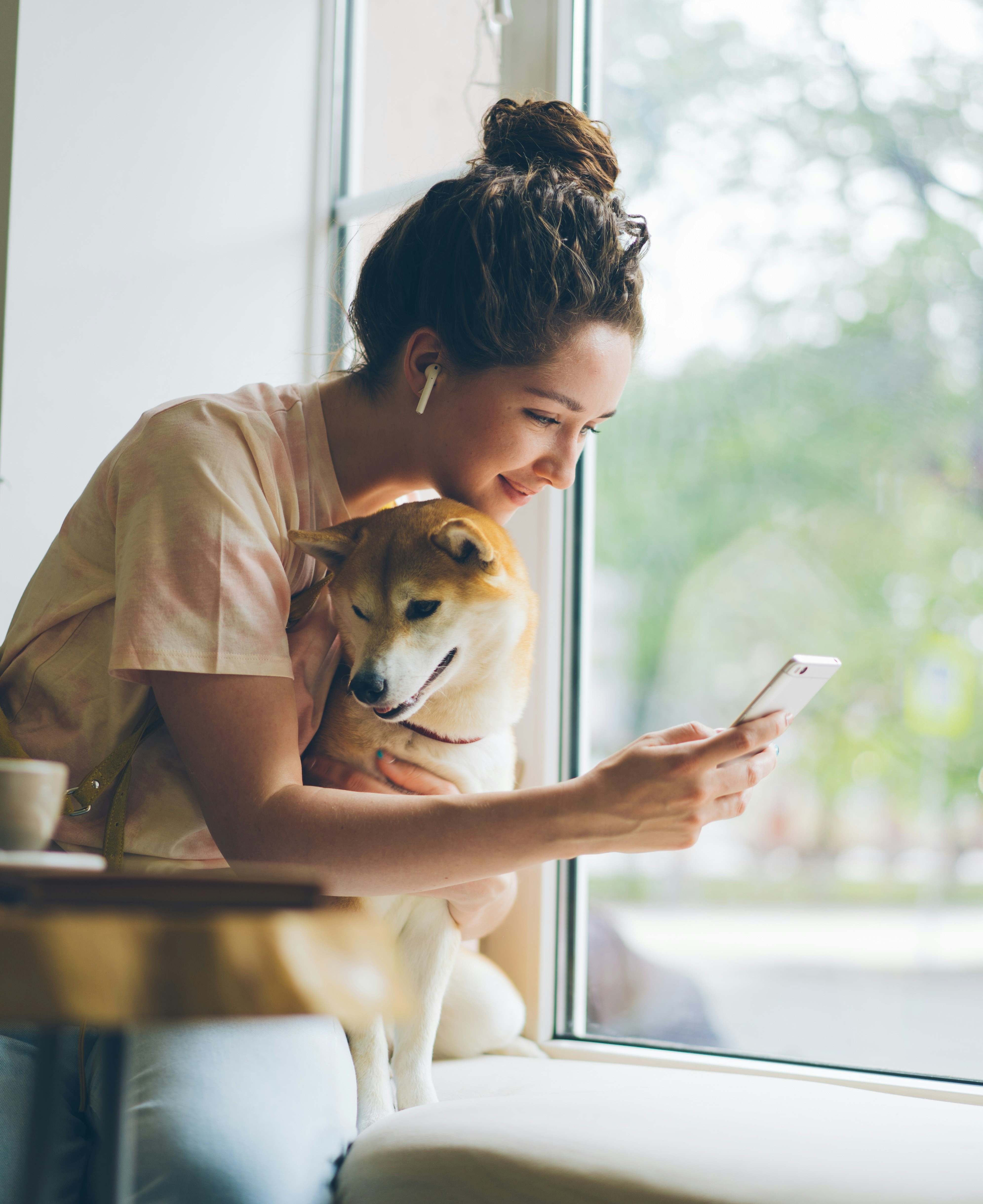 A dog and a cat next to a smartphone