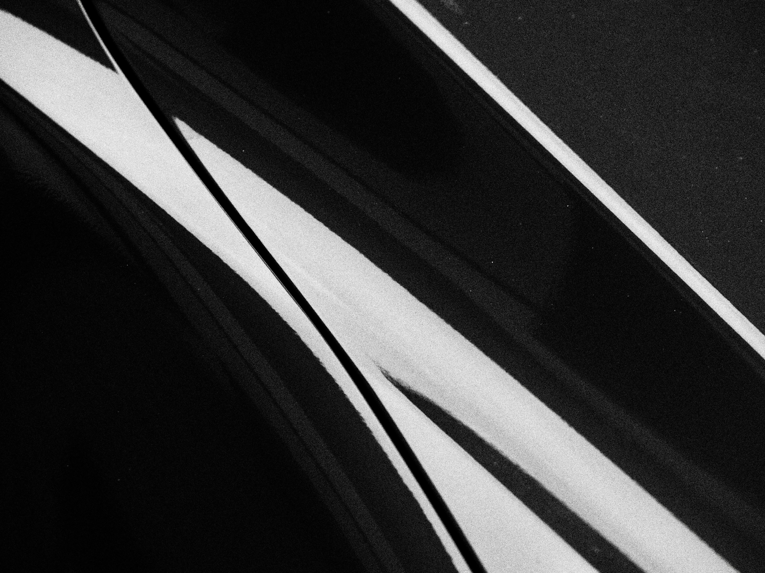 Body contours and reflections on a dark car panel