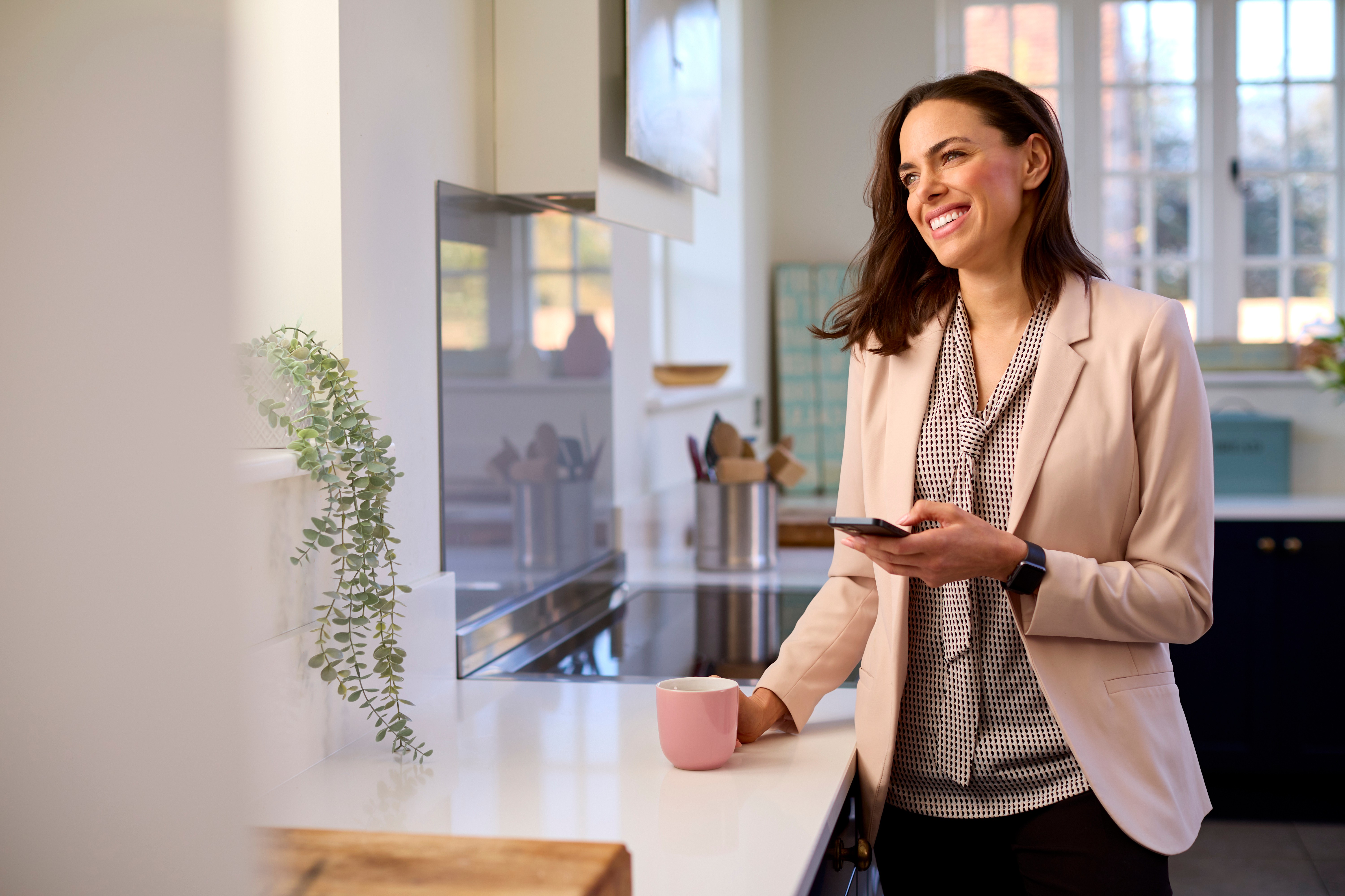 two people in a workspace working on their laptops