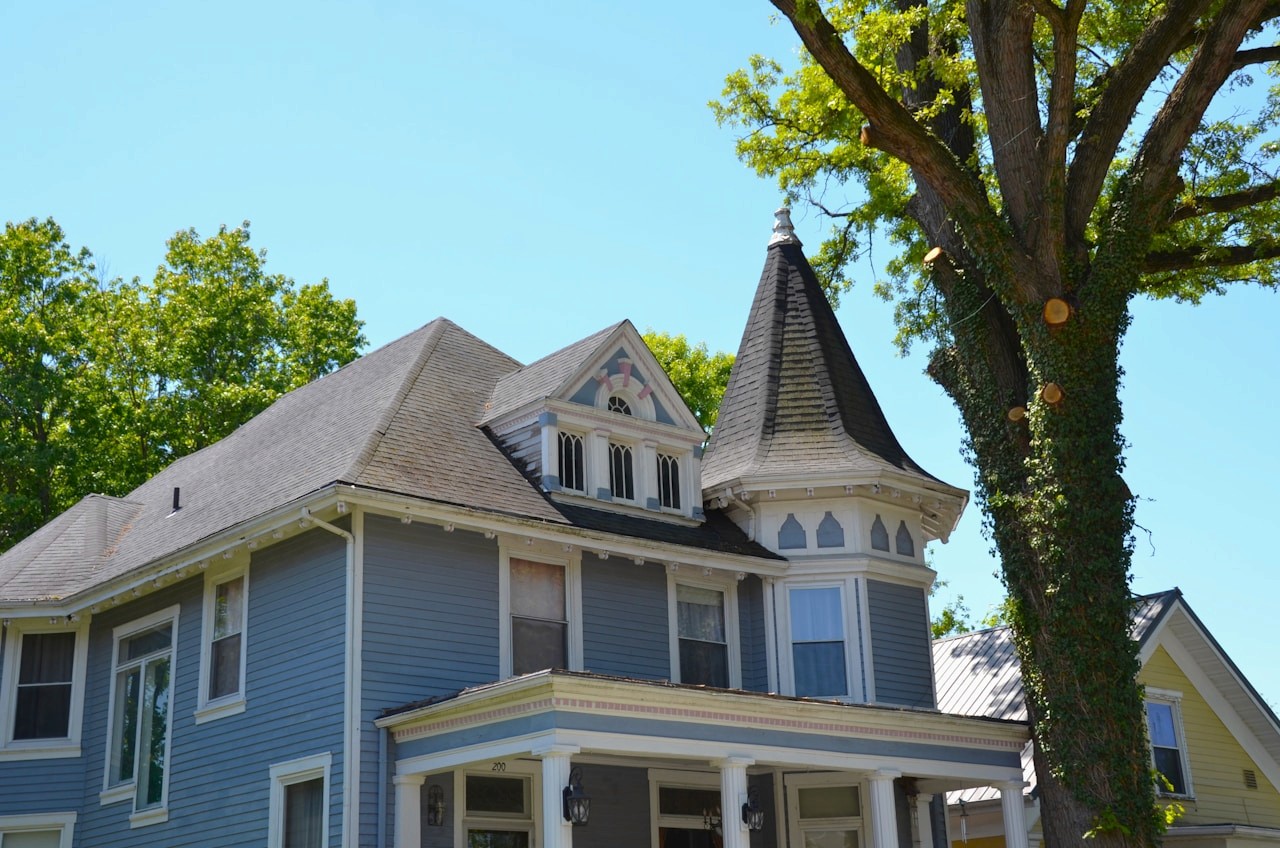Blue Victorian house with a turret roof