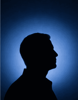Headshot of a smiling young man with styled brown hair.