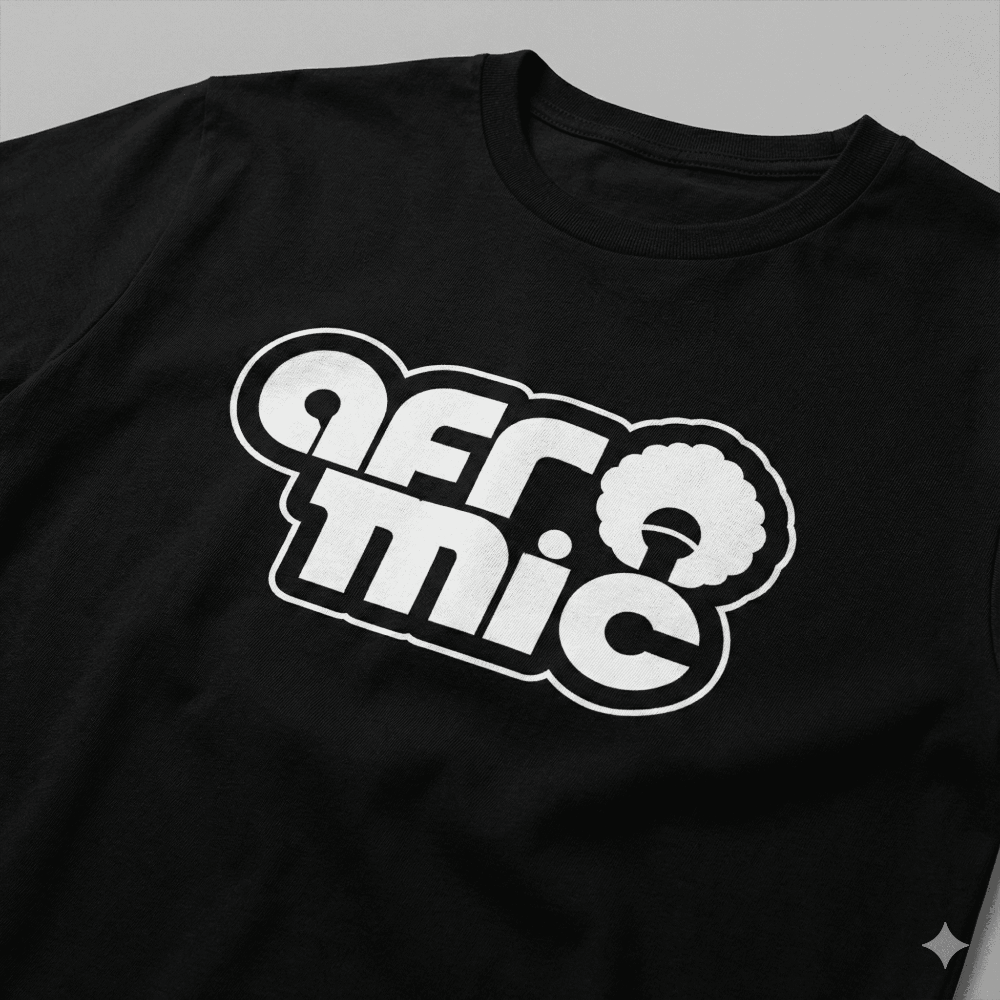 Man wearing a black Afromic branded t-shirt and bucket hat in an urban, street-style setting.