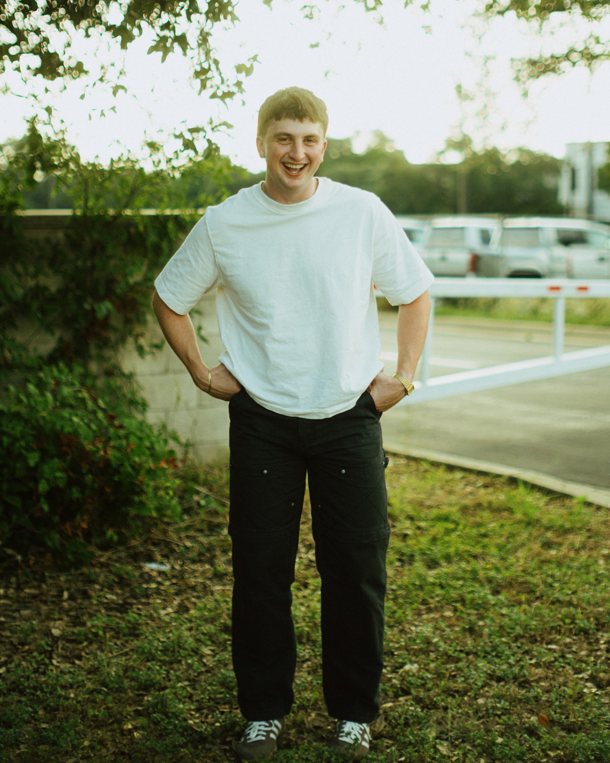 Portrait of a person in a pink sweater against a light background