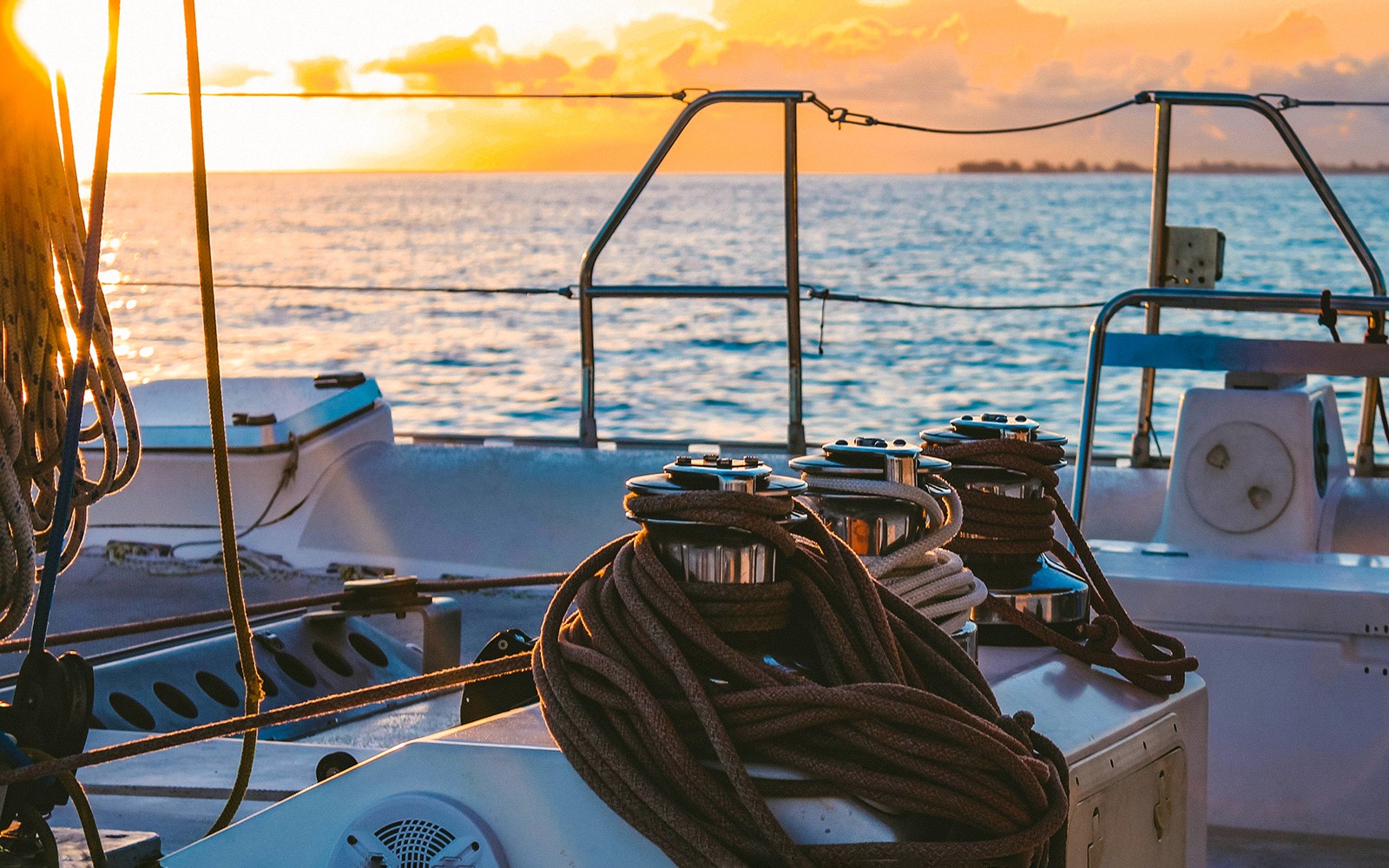 Catamaran deck at sunset on the sea near Valencia.