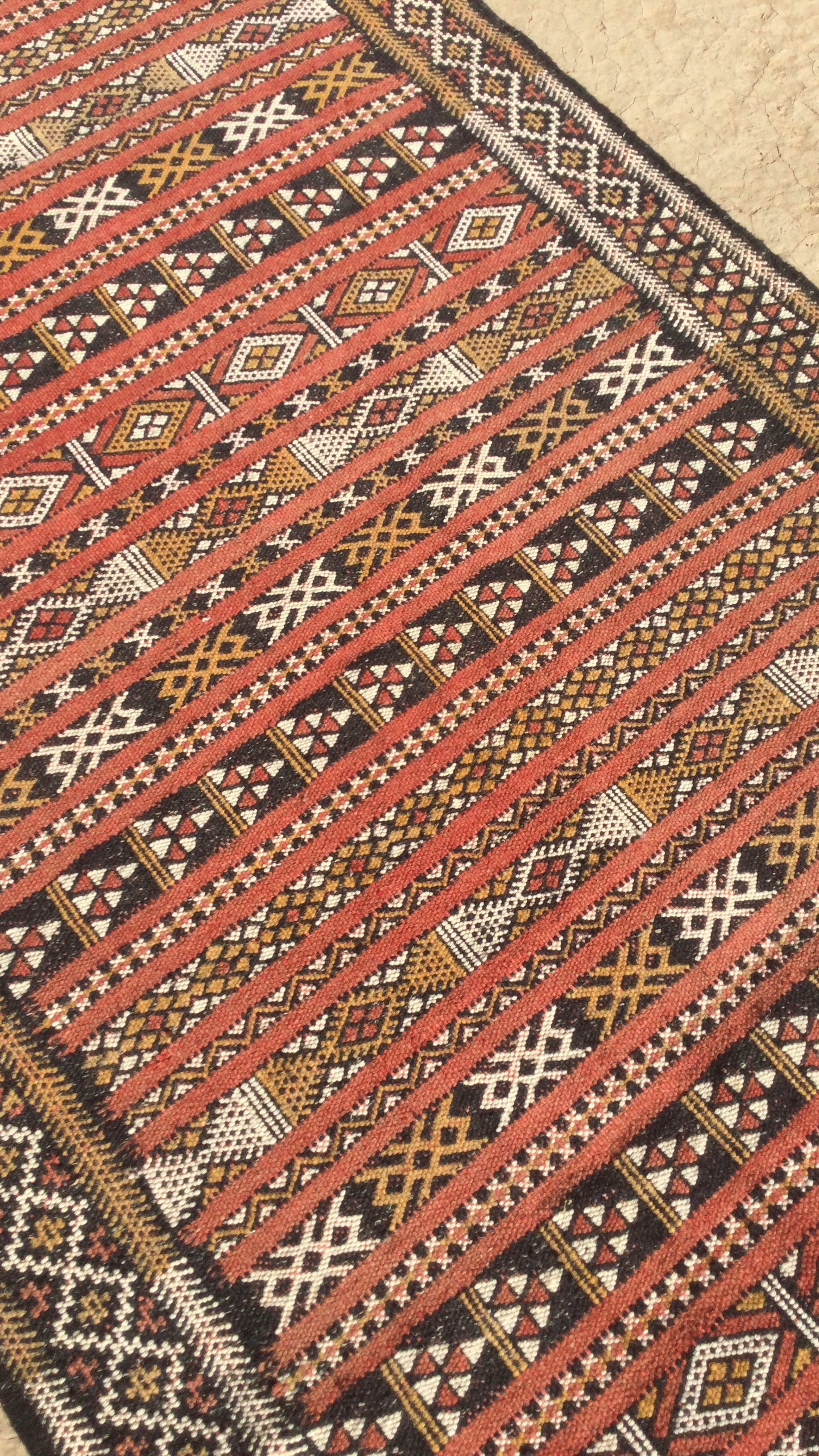 A red and black area rug on the floor