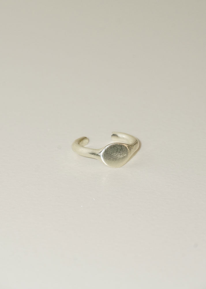 Silver ring on a light gray background
