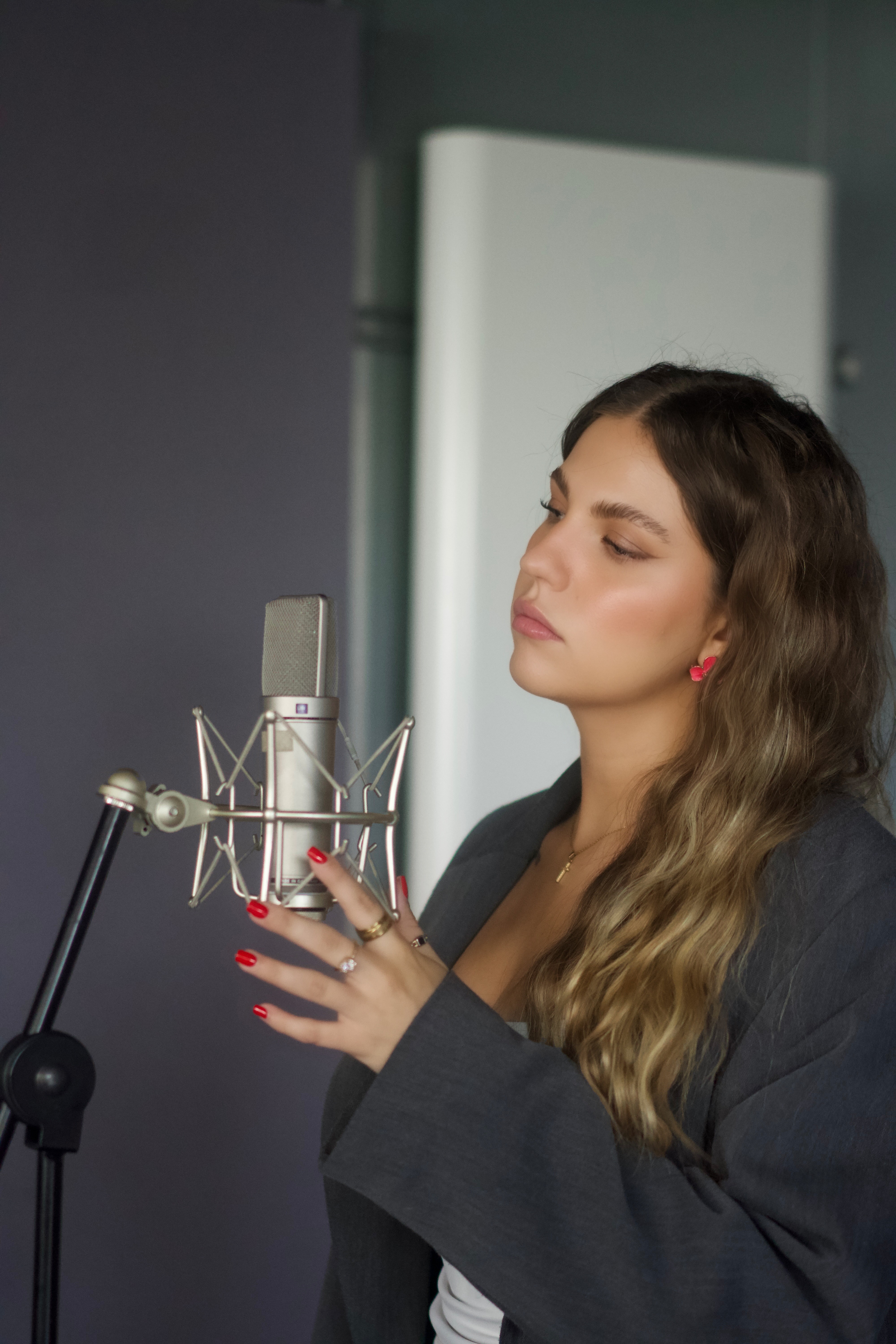 India in front of the mic in the studion a