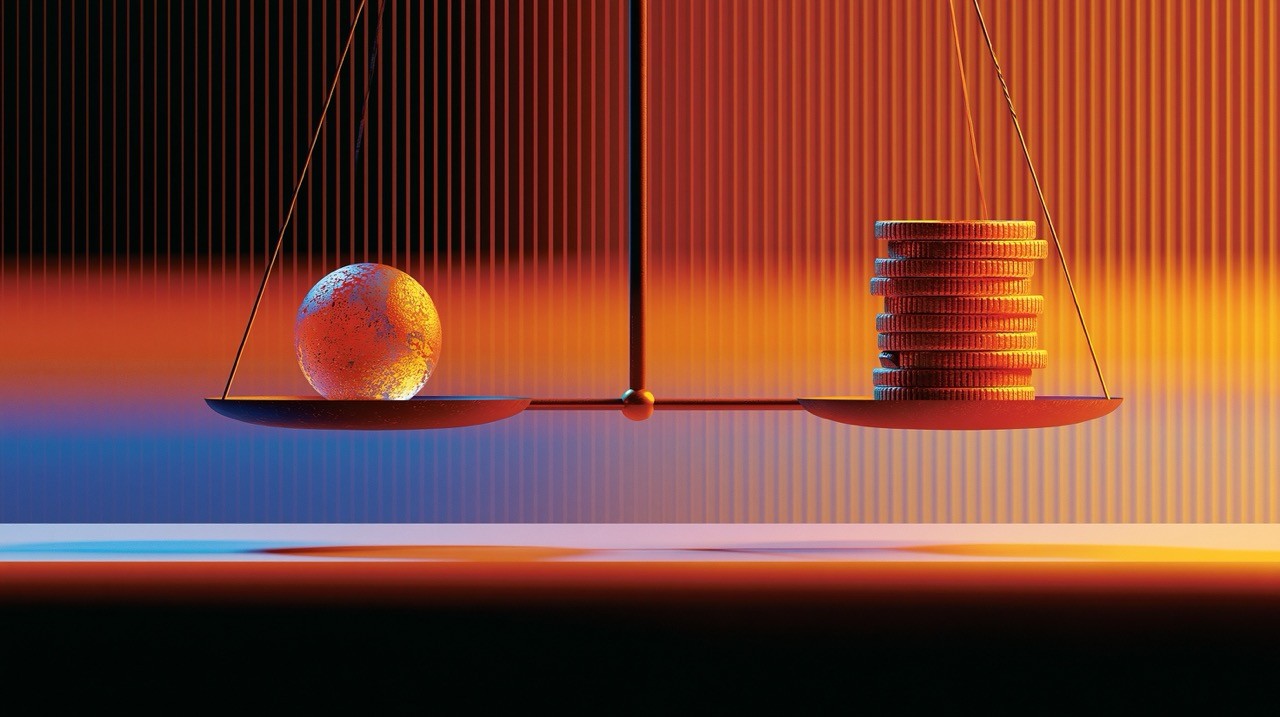 Delicate balance scale holding a miniature globe on one side and stacked gold coins on the other,