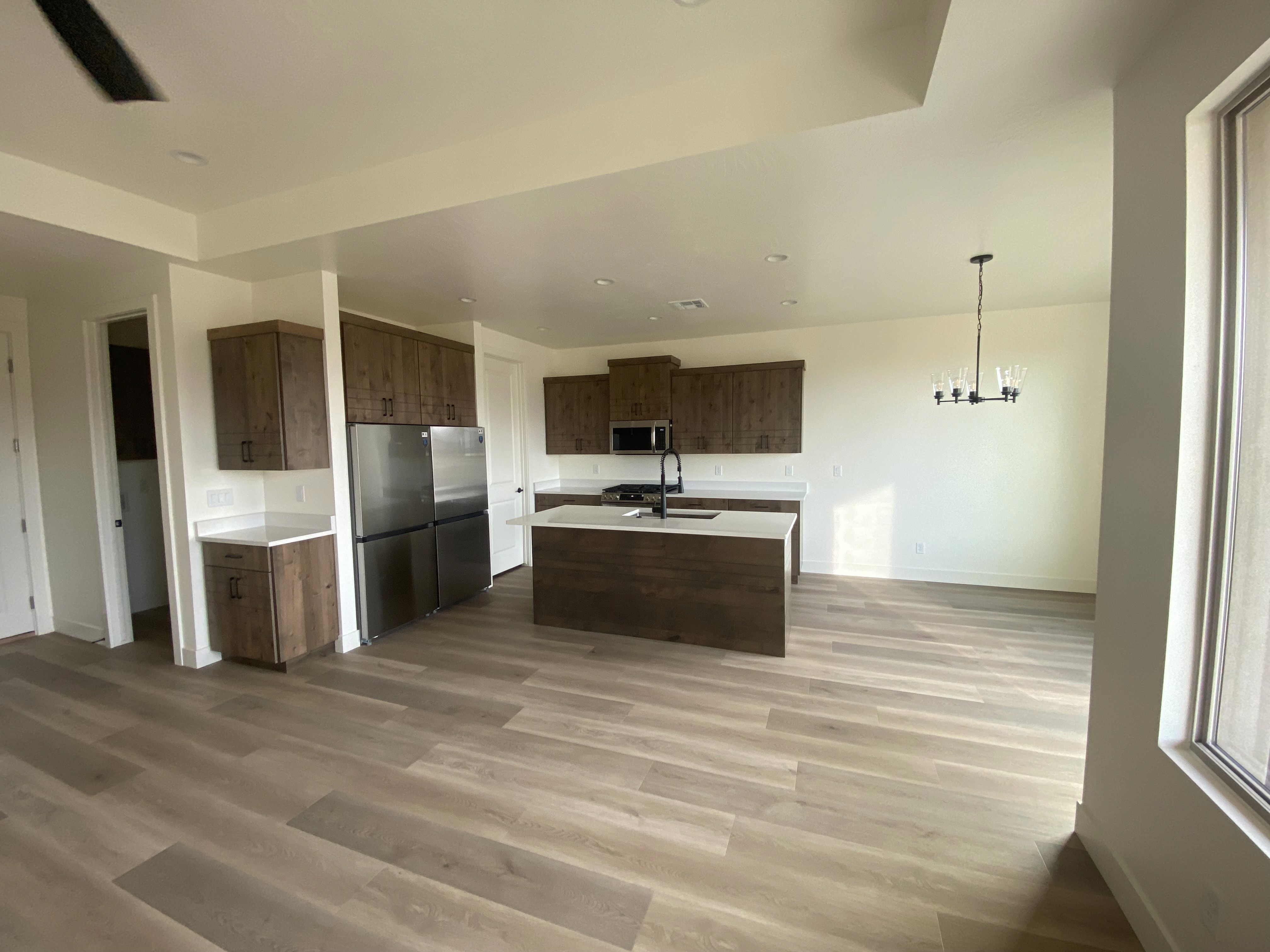 Kitchen view in the Golden Hour home in Hurricane, Utah with open layout connecting to the dining space.