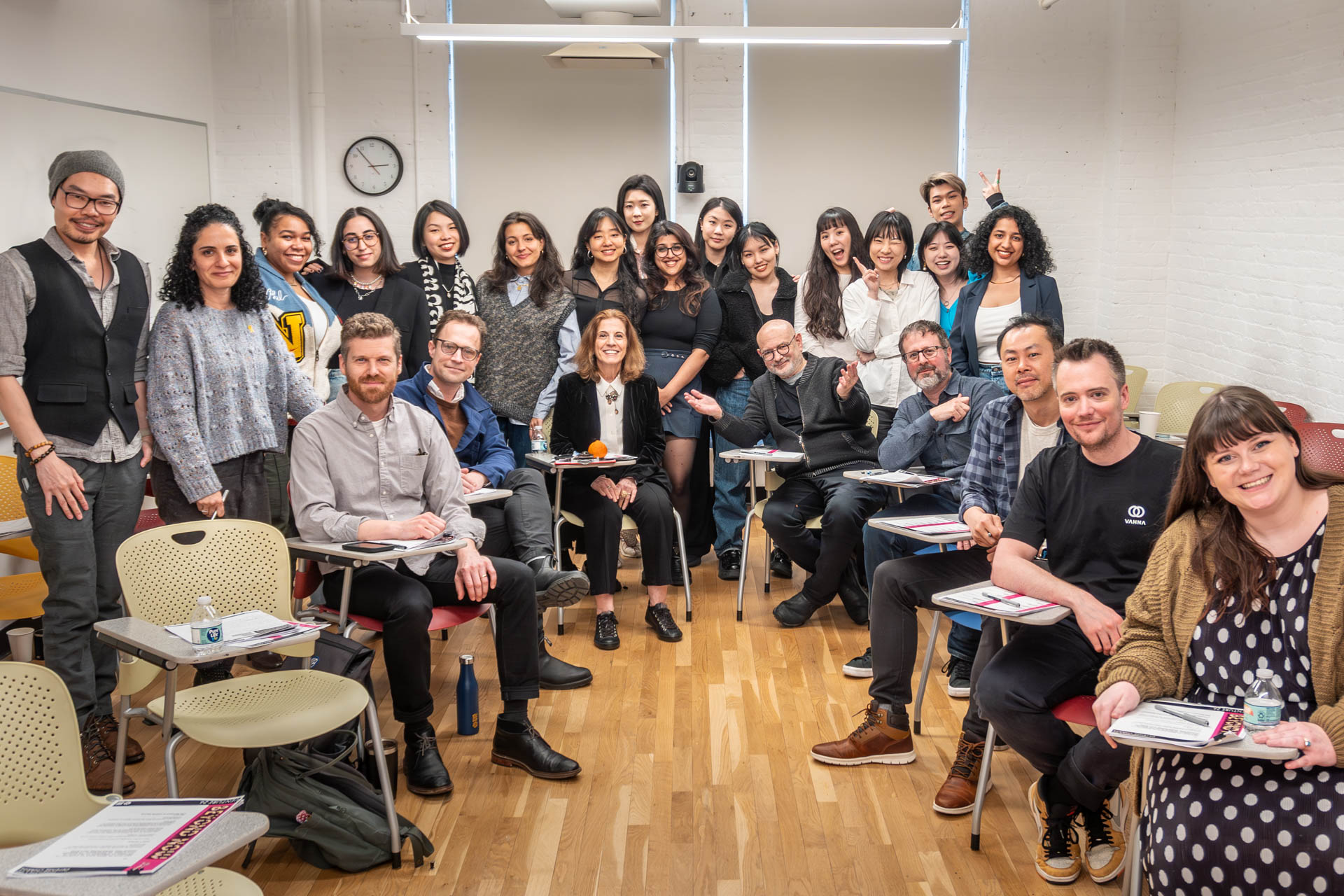 Group shot in a classroom of students, their instructors and their mentors