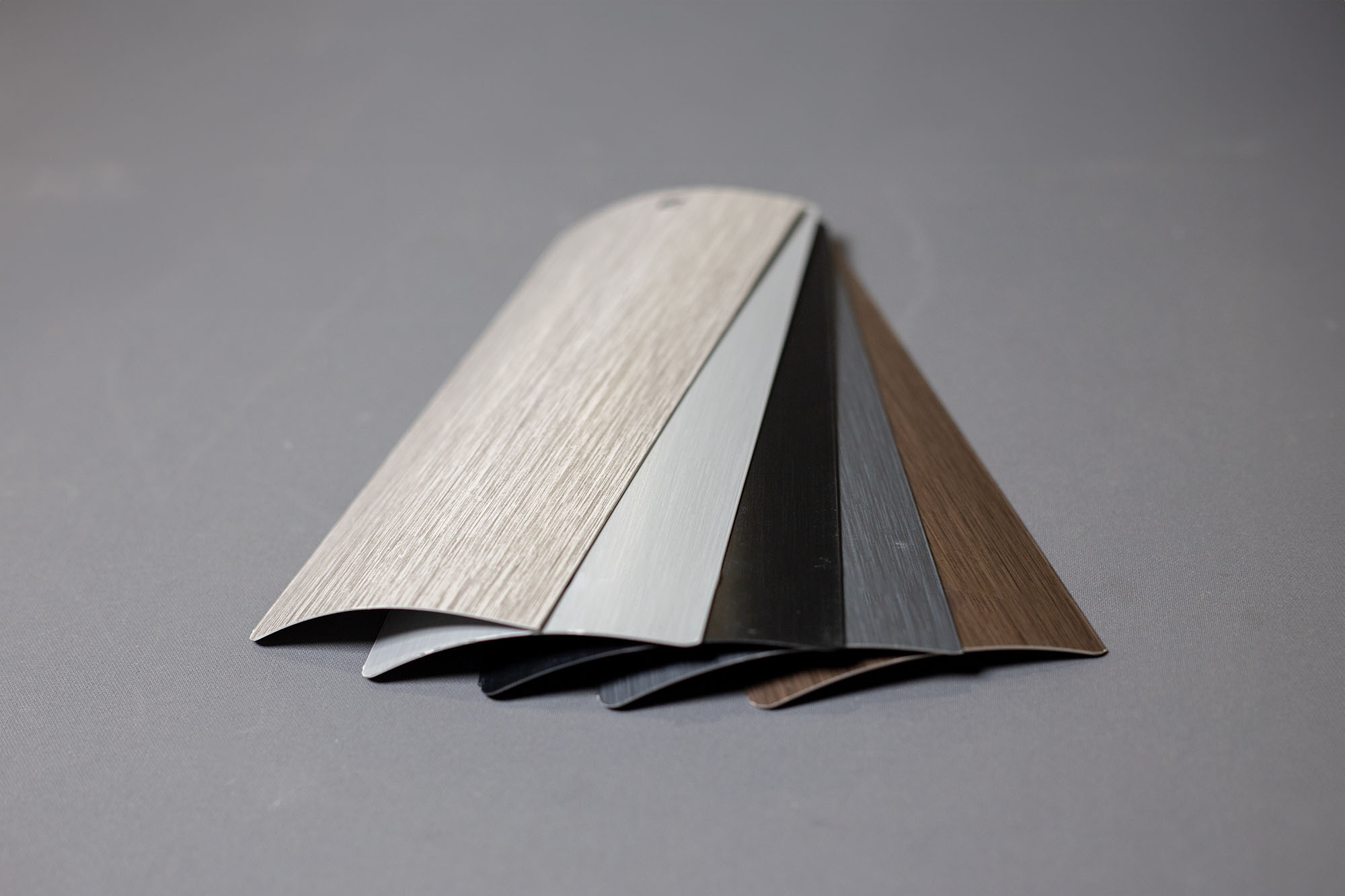 Two people sit across a table in a stylish room with red velvet walls and a large red pendant light. The mood is intimate and modern.