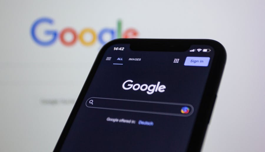 a black smartphone against a white background with the google logo